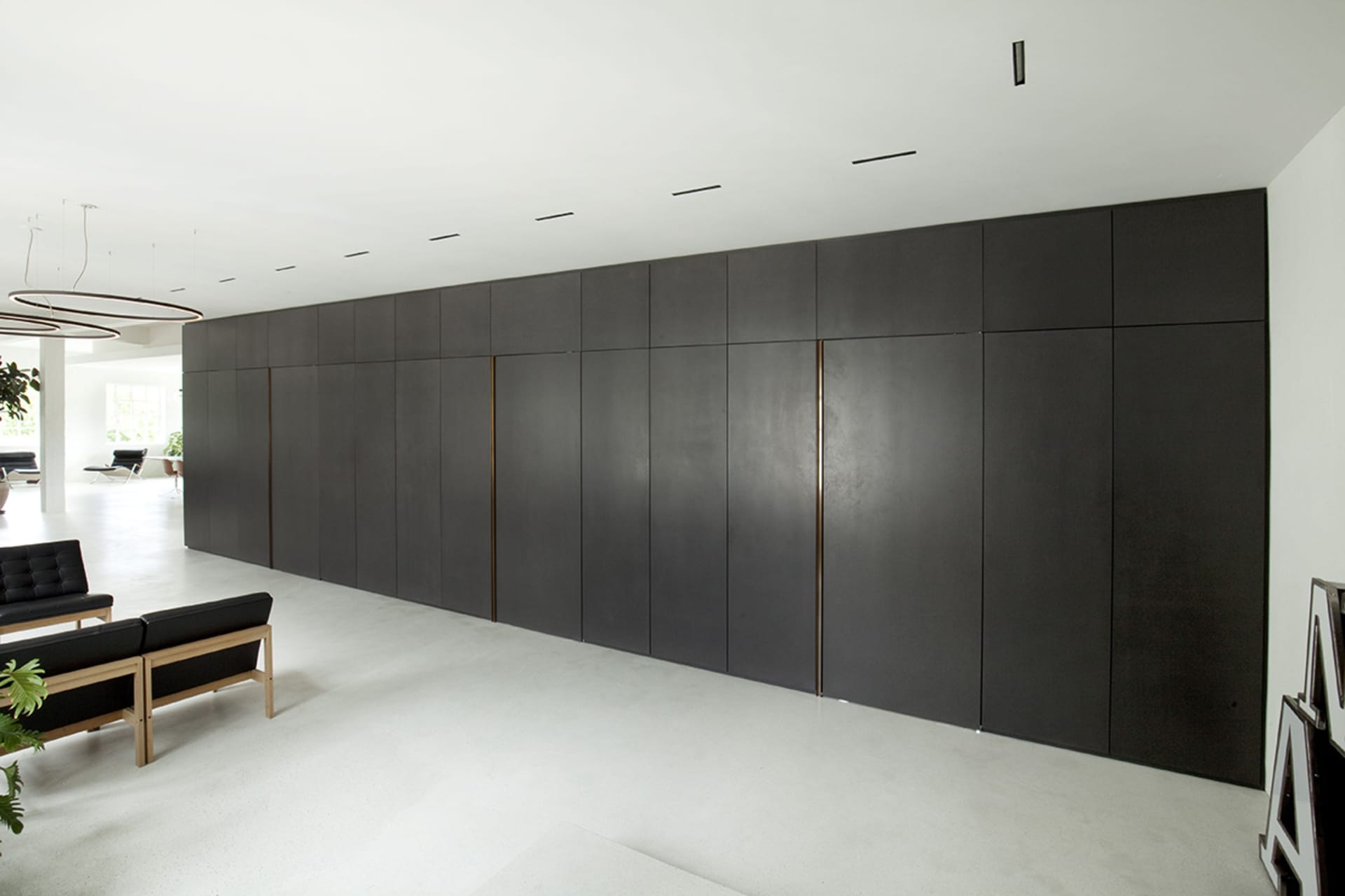 A minimalist office space featuring concrete and metal materials.