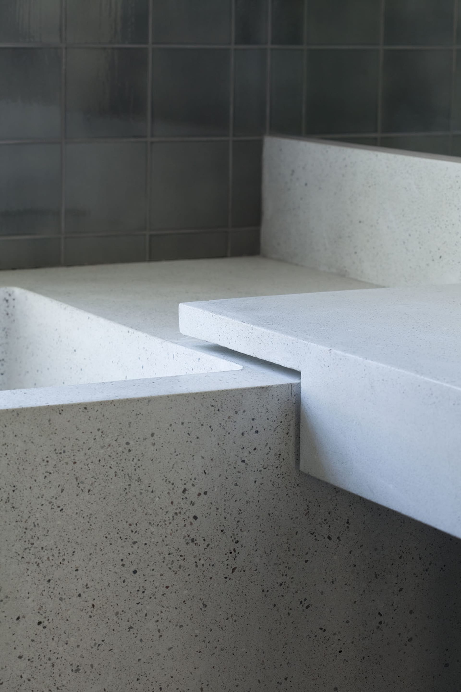 A minimalist bathroom featuring concrete walls and flooring.