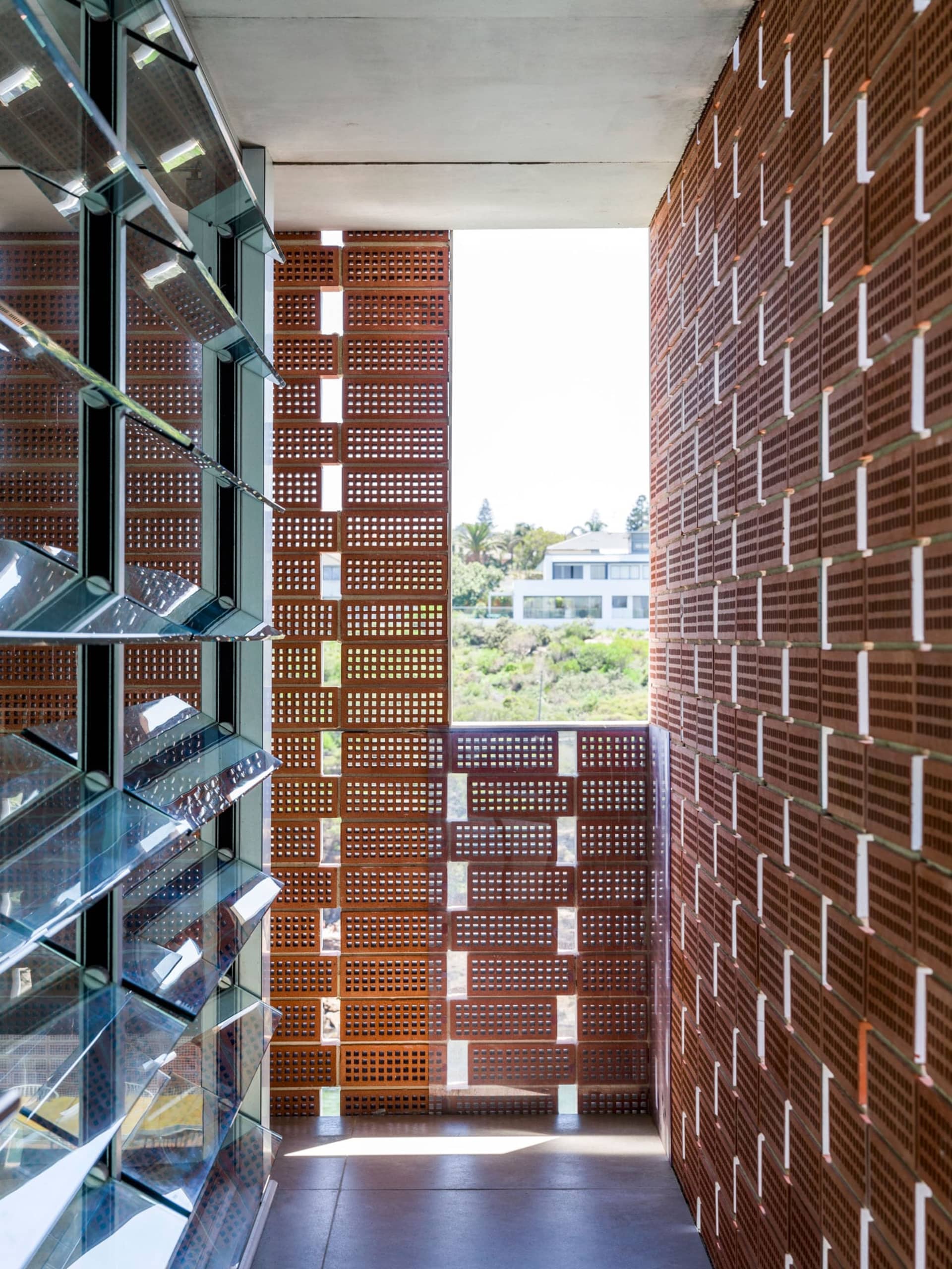 Modern interior space featuring brick, glass, and concrete materials.