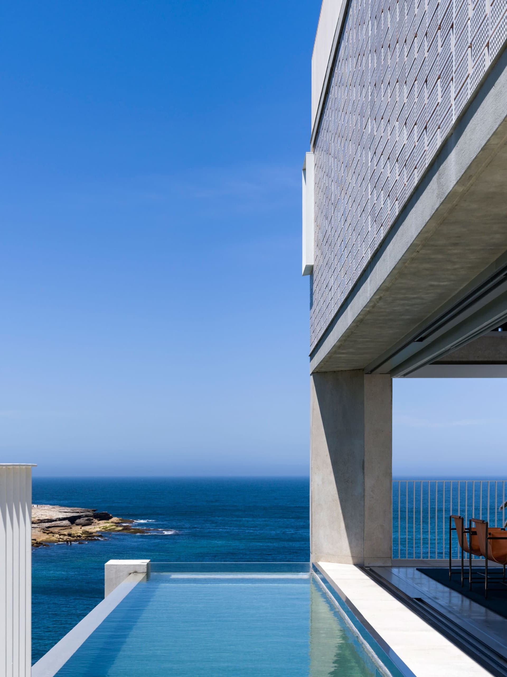 Modern exterior of a residential building featuring glass and steel materials.