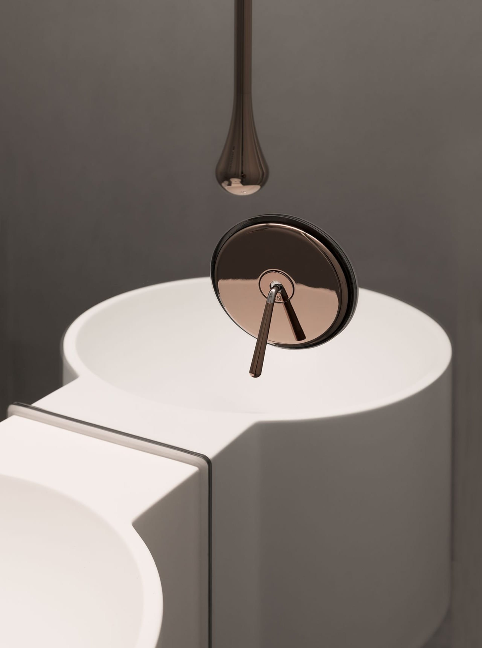 Close-up of a modern white bathroom sink with a ceramic faucet.