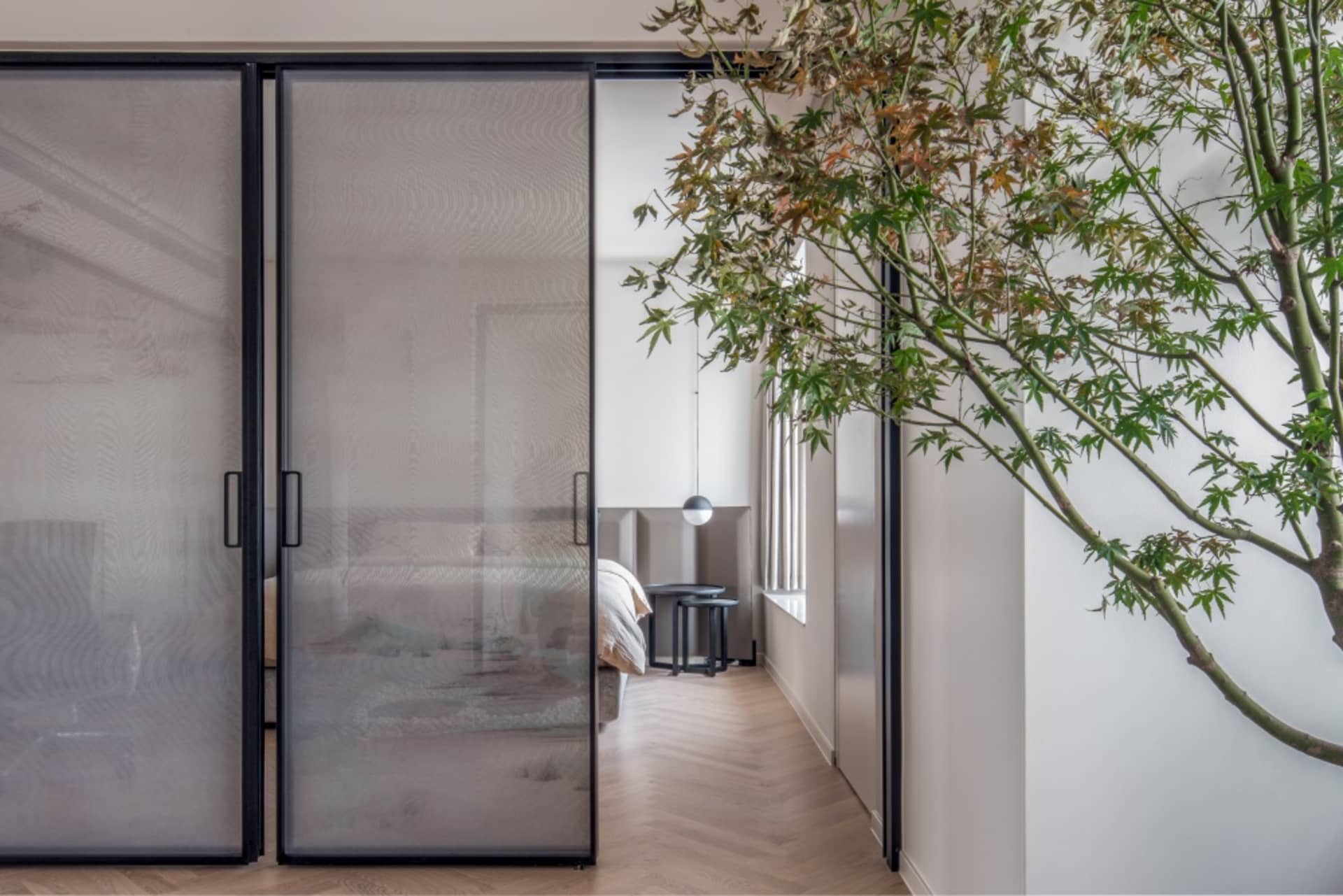 Modern bedroom suite featuring glass and steel design elements.