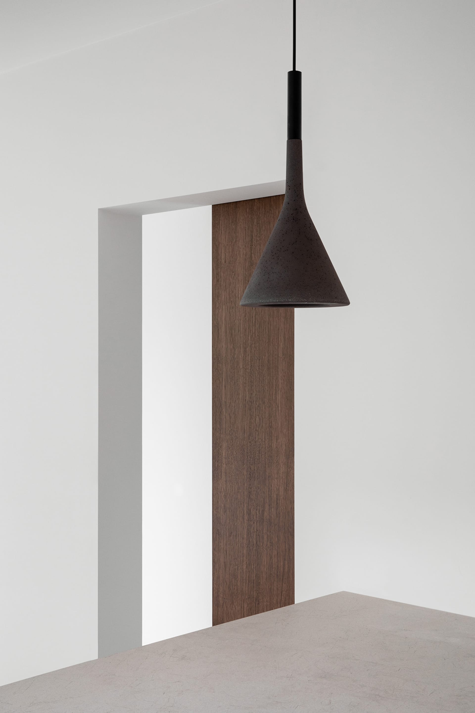 A minimalist interior design featuring a wooden panel.