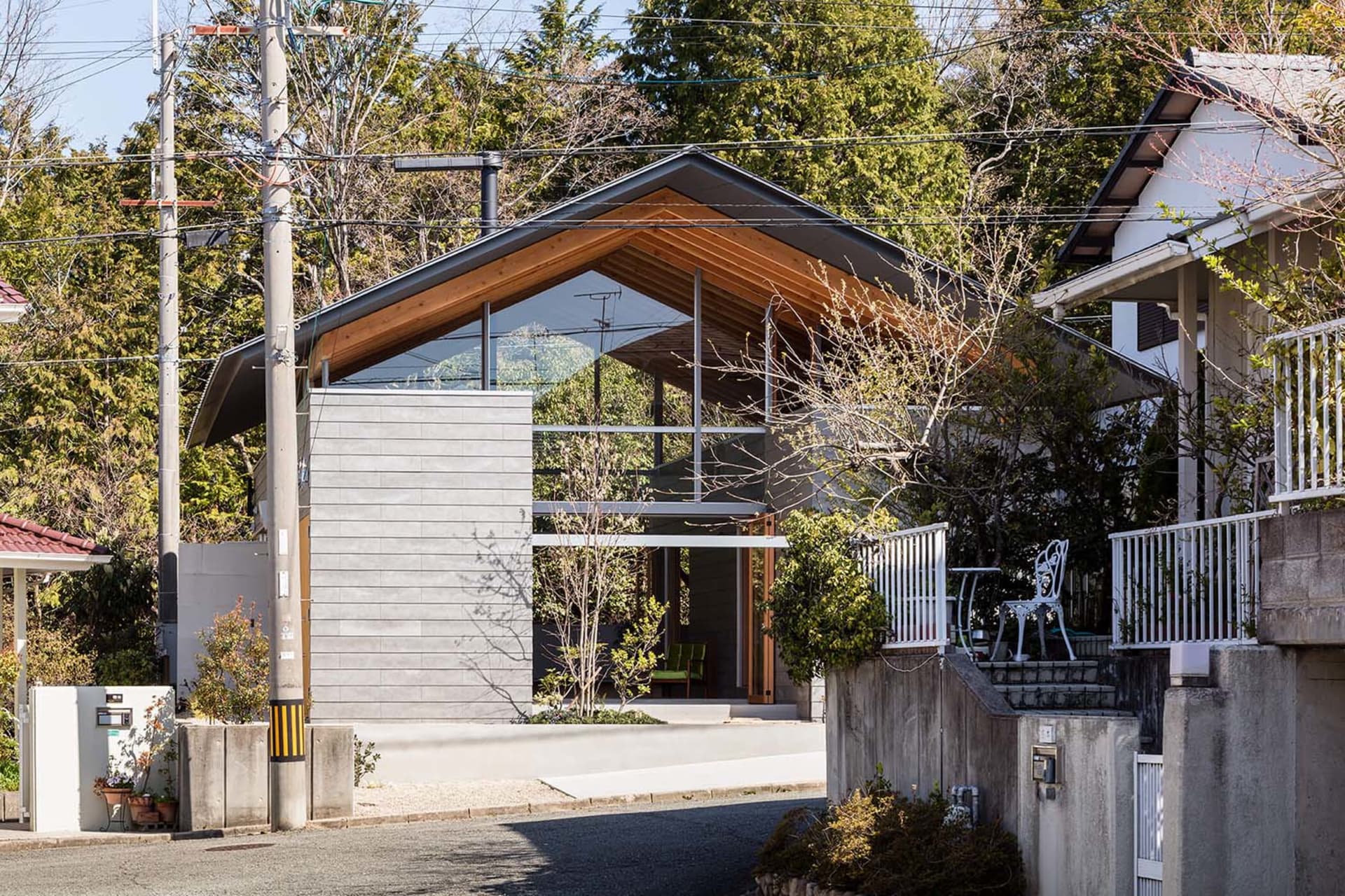 A modern house with a combination of concrete and glass exterior materials.