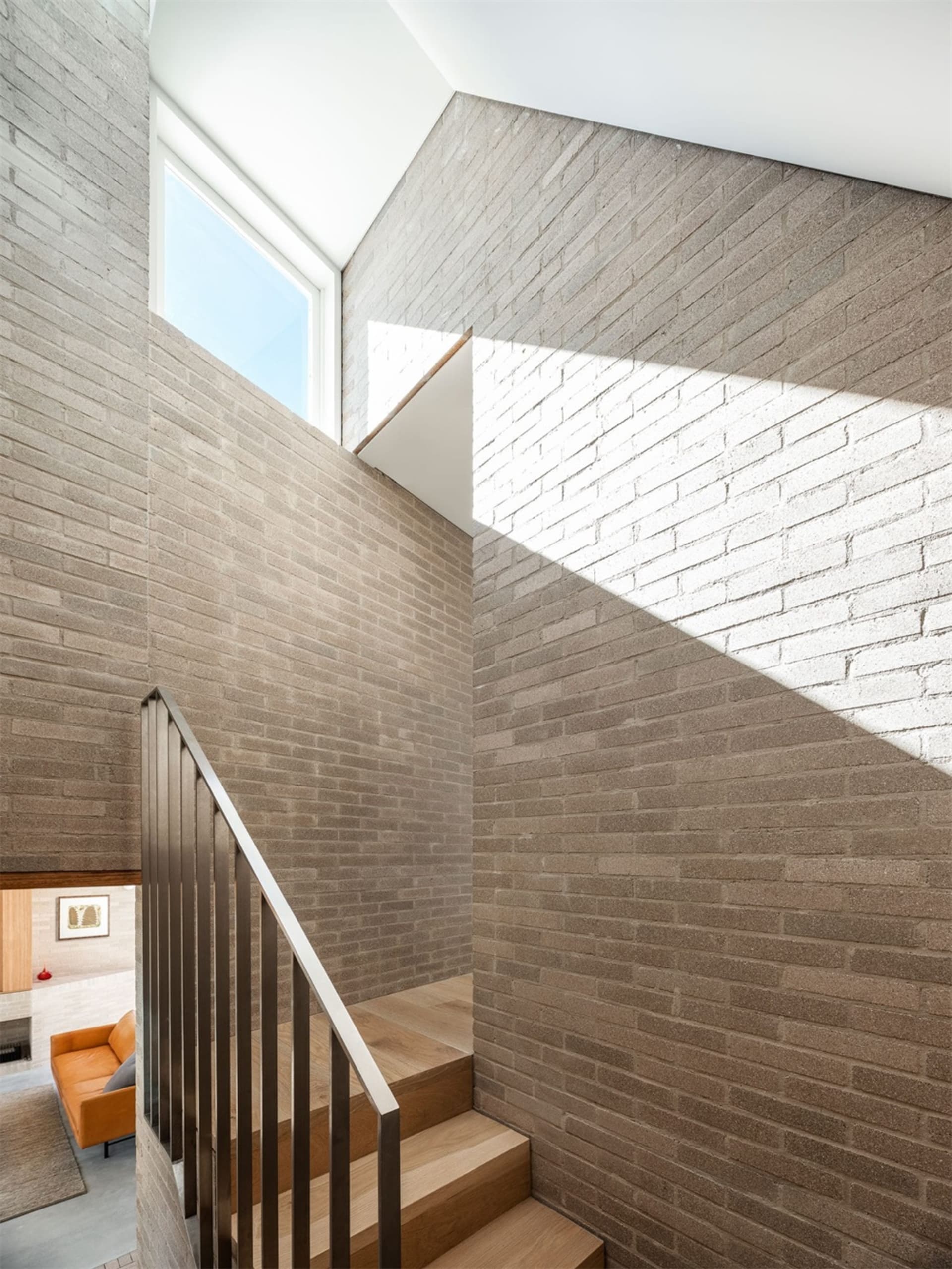 Modern stairs with brick walls and wooden steps.