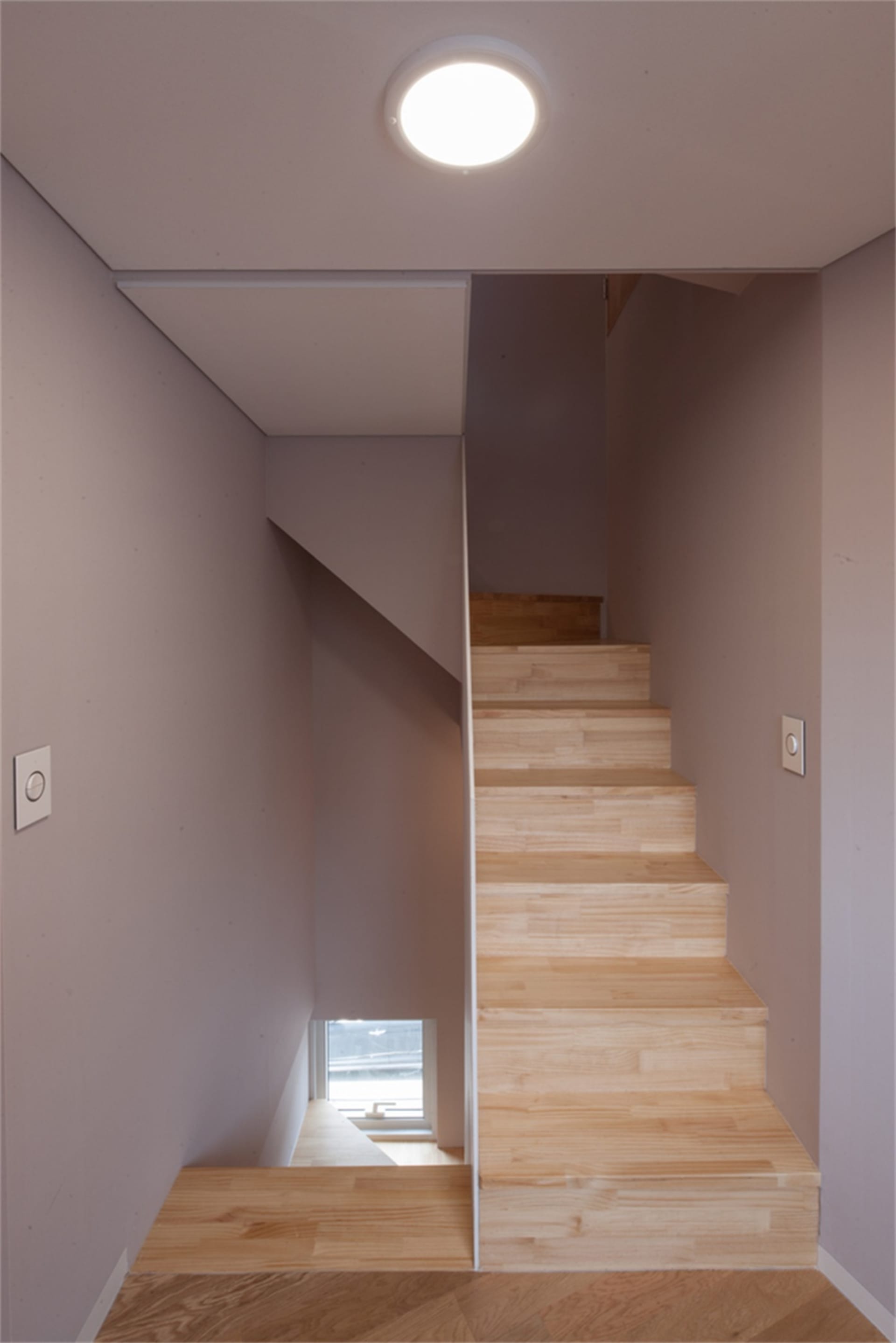 Minimalist architectural staircase with wooden steps and simple, clean lines.