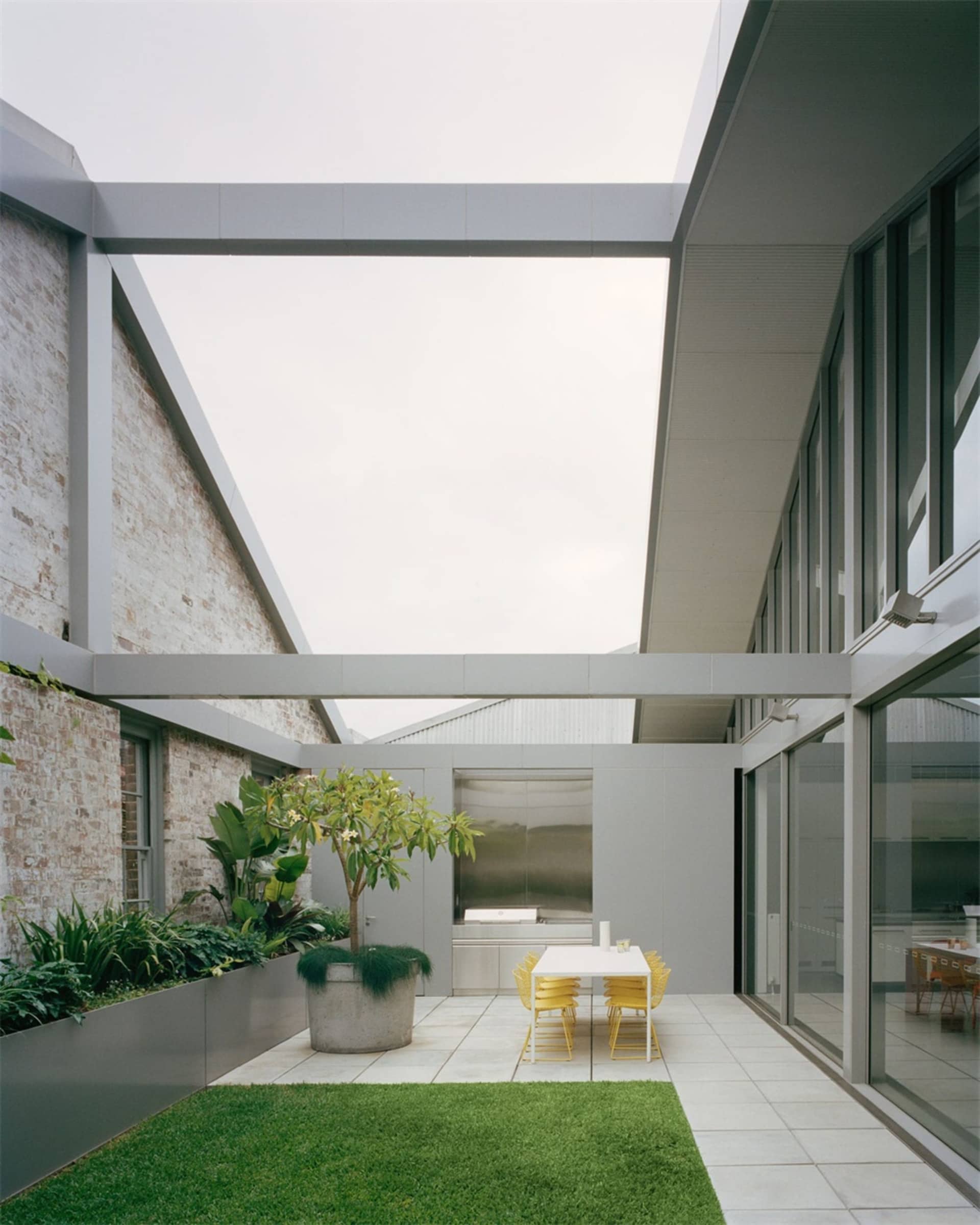 Concrete, glass, and steel patio area with modern minimalistic design.