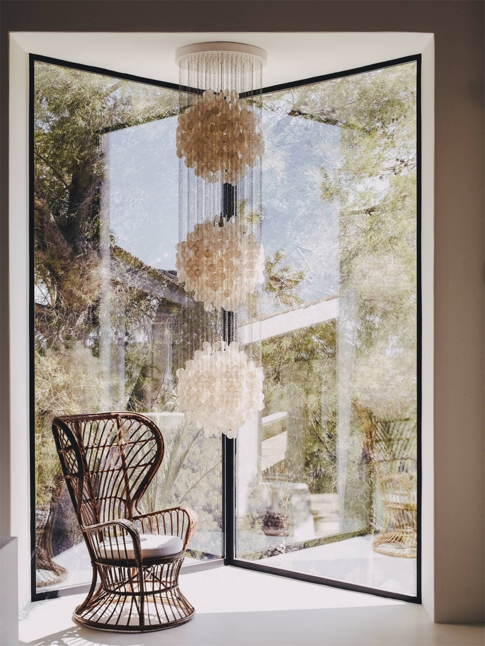 A modern wooden chair with a glass window in the background.