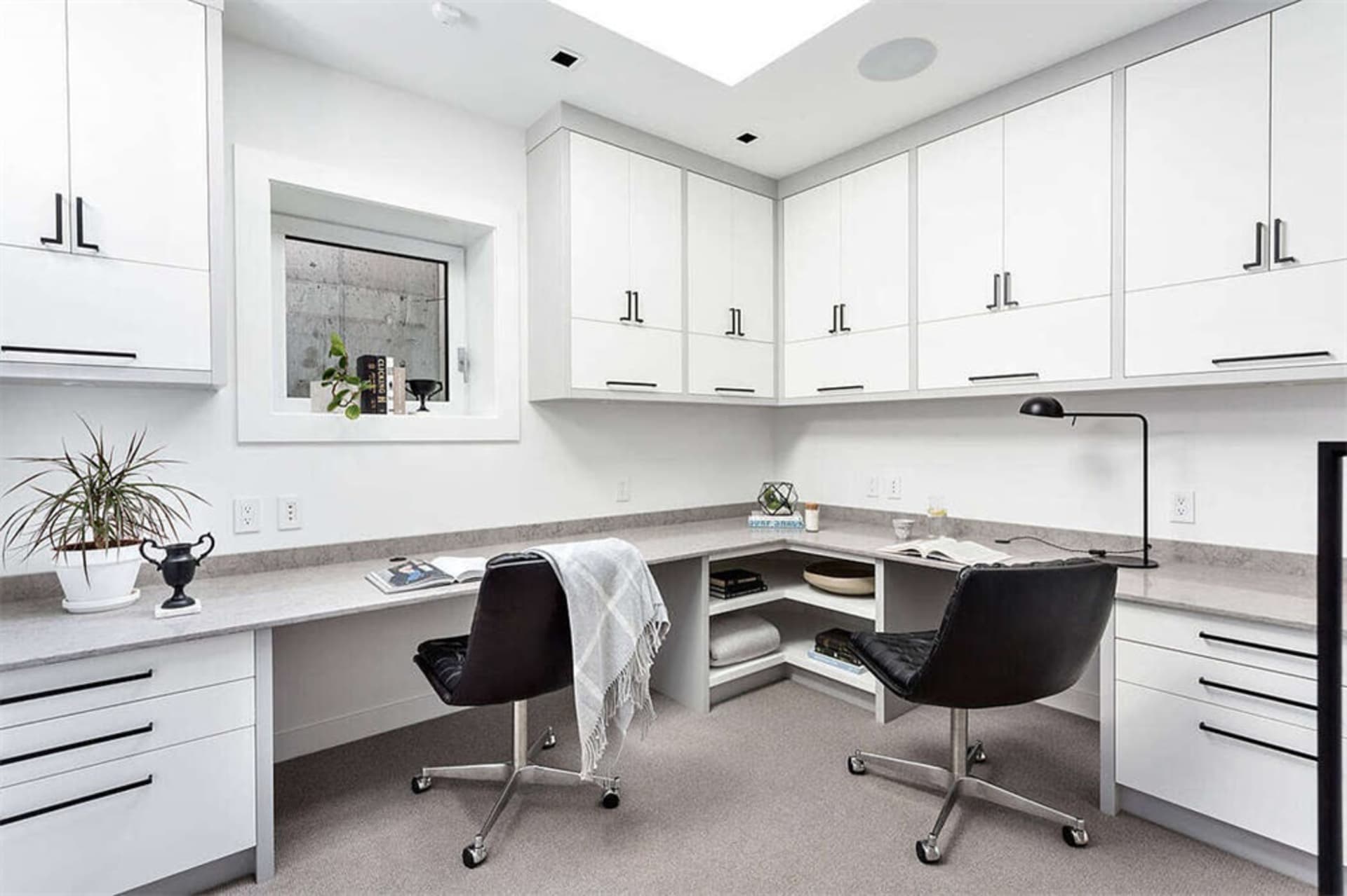 A modern home office featuring concrete and steel finishes.