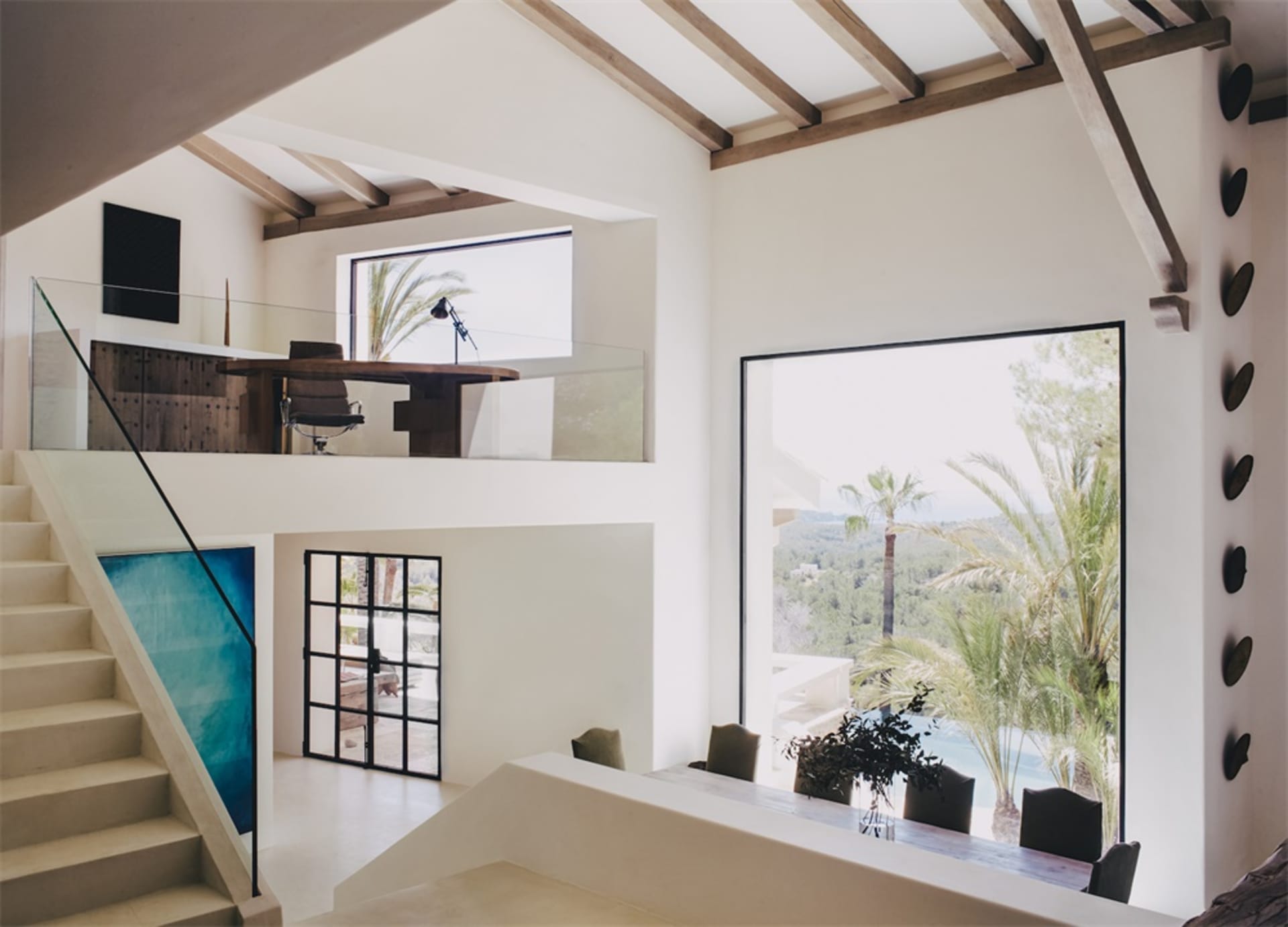 Modern residential interior with concrete, wood, and glass elements.