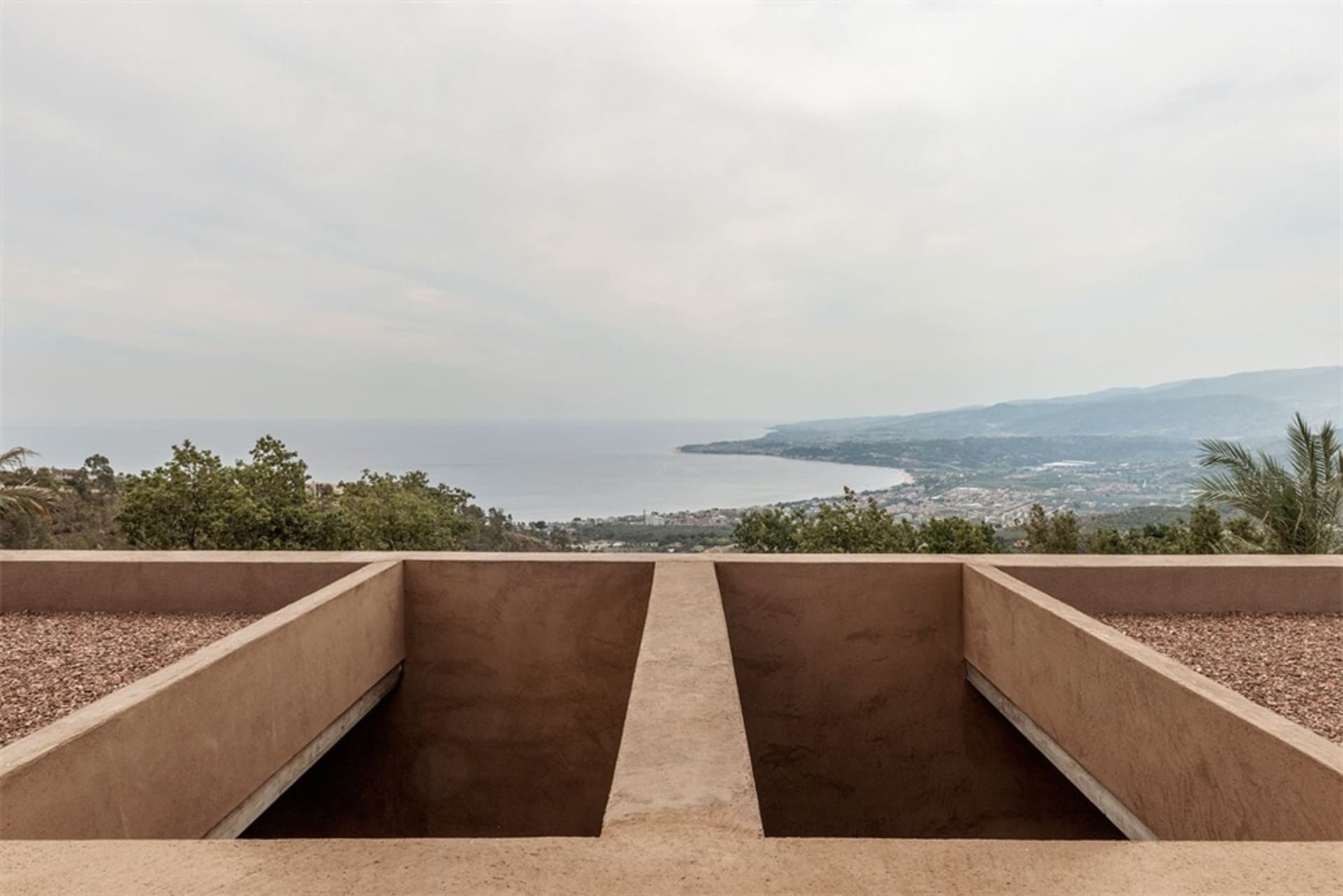 A view of mountains and a body of water from a raised vantage point.