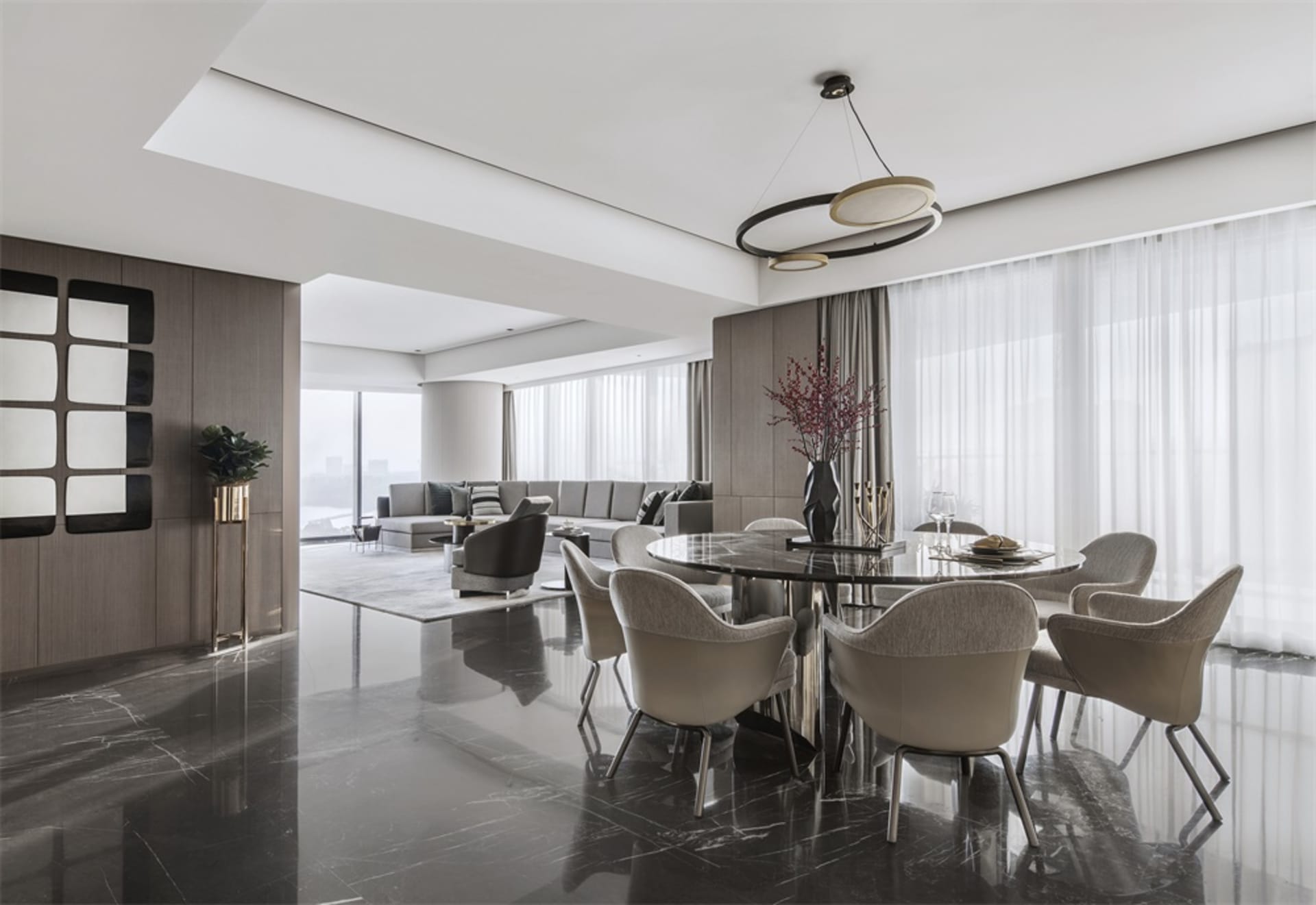 A modern dining room with marble flooring, fabric chairs, and wooden elements.