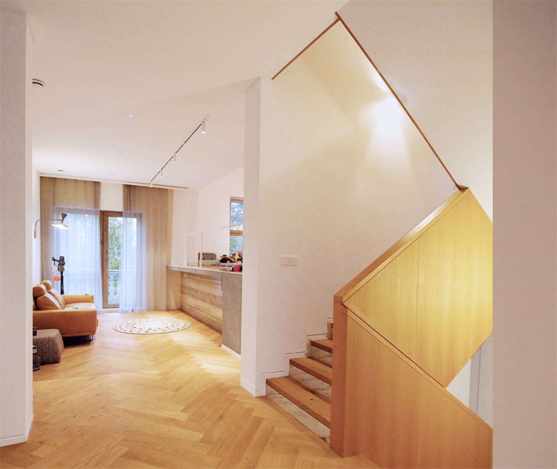 A modern residential interior featuring a wooden hardwood floor.