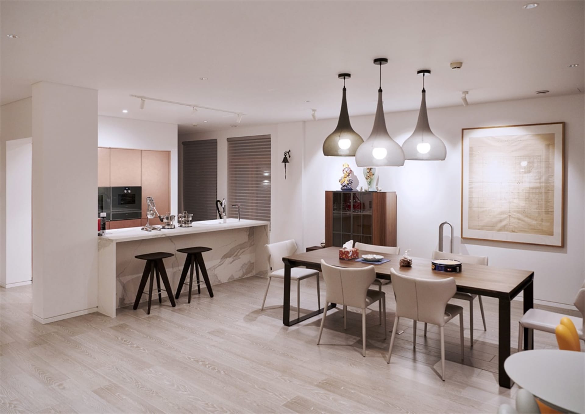 Modern kitchen and dining area with white marble countertops and flooring, pendant lights, and minimalist design.