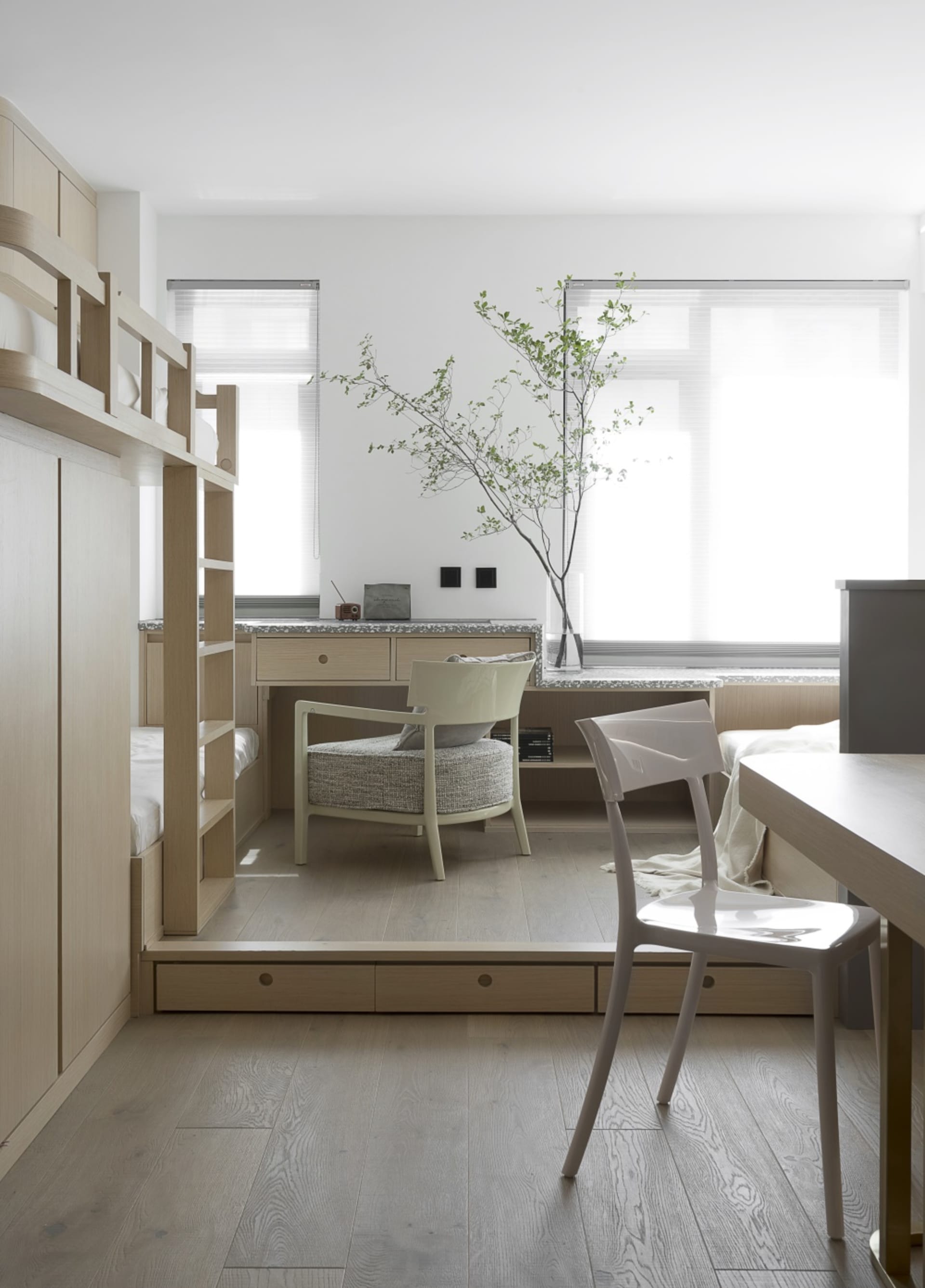 Minimalist bedroom featuring wood furniture and natural light.