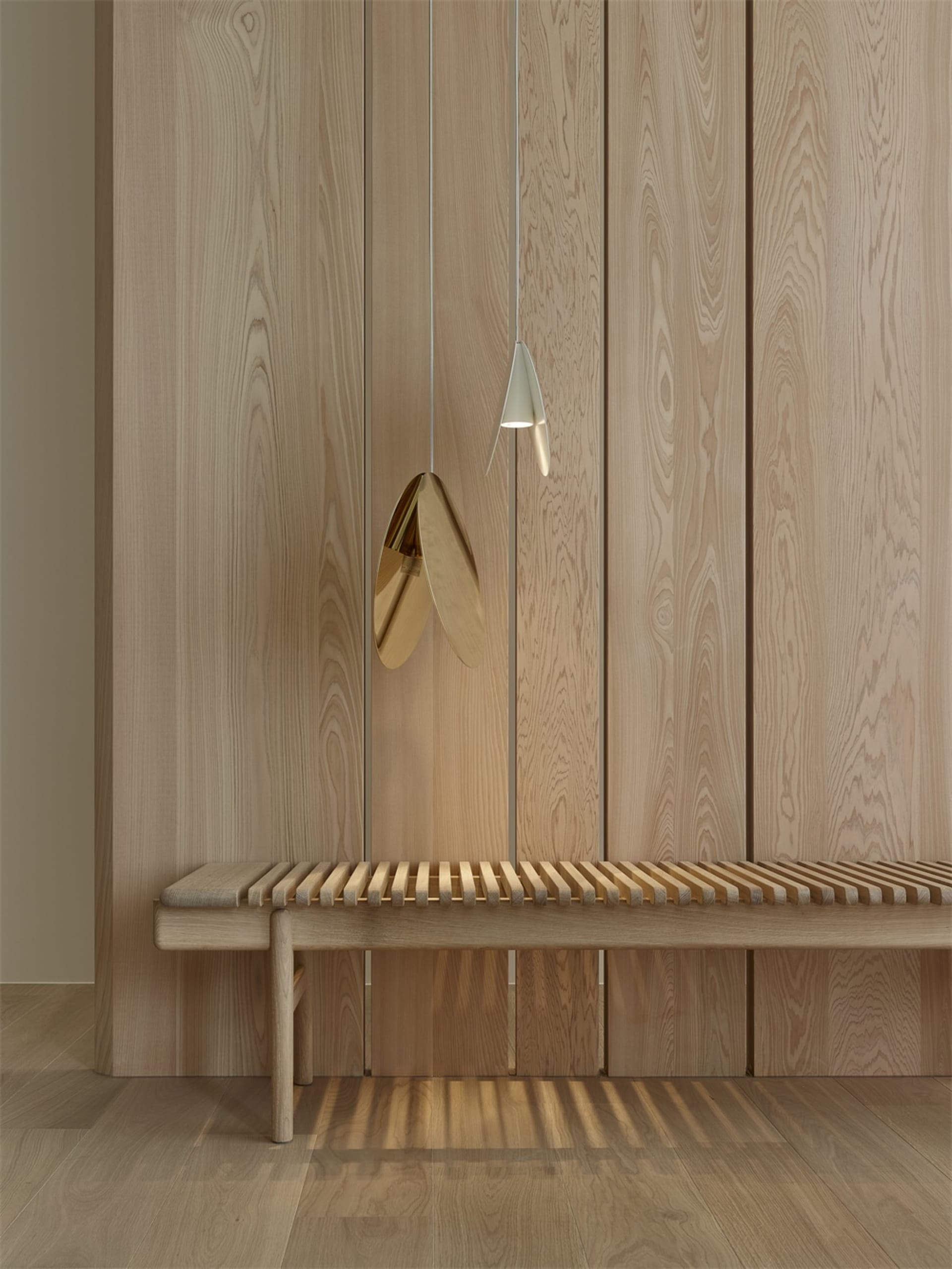 Minimalist wooden bench in a contemporary setting with a unique pendant light hanging above it.