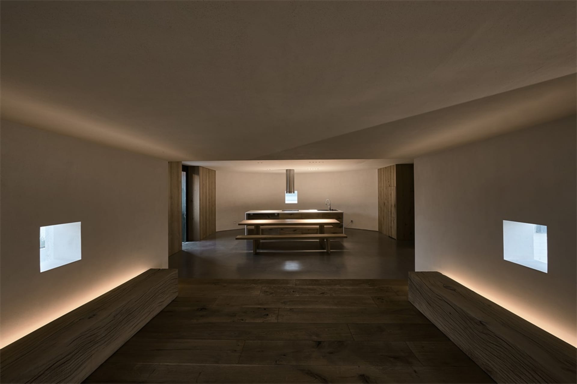 Clean, modern residential interior with concrete walls and floor.