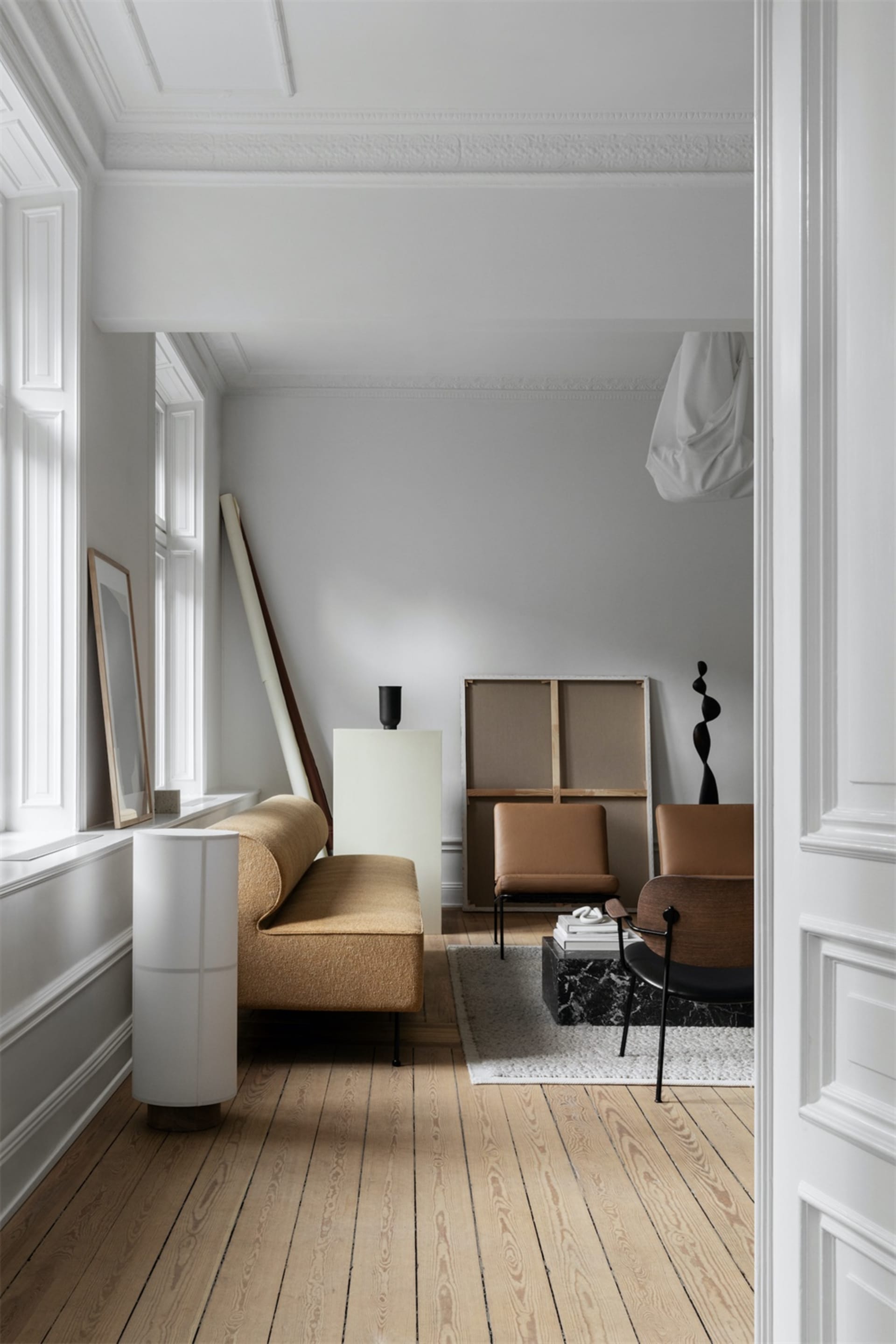 Modern living room with minimalist furniture in white color palette.