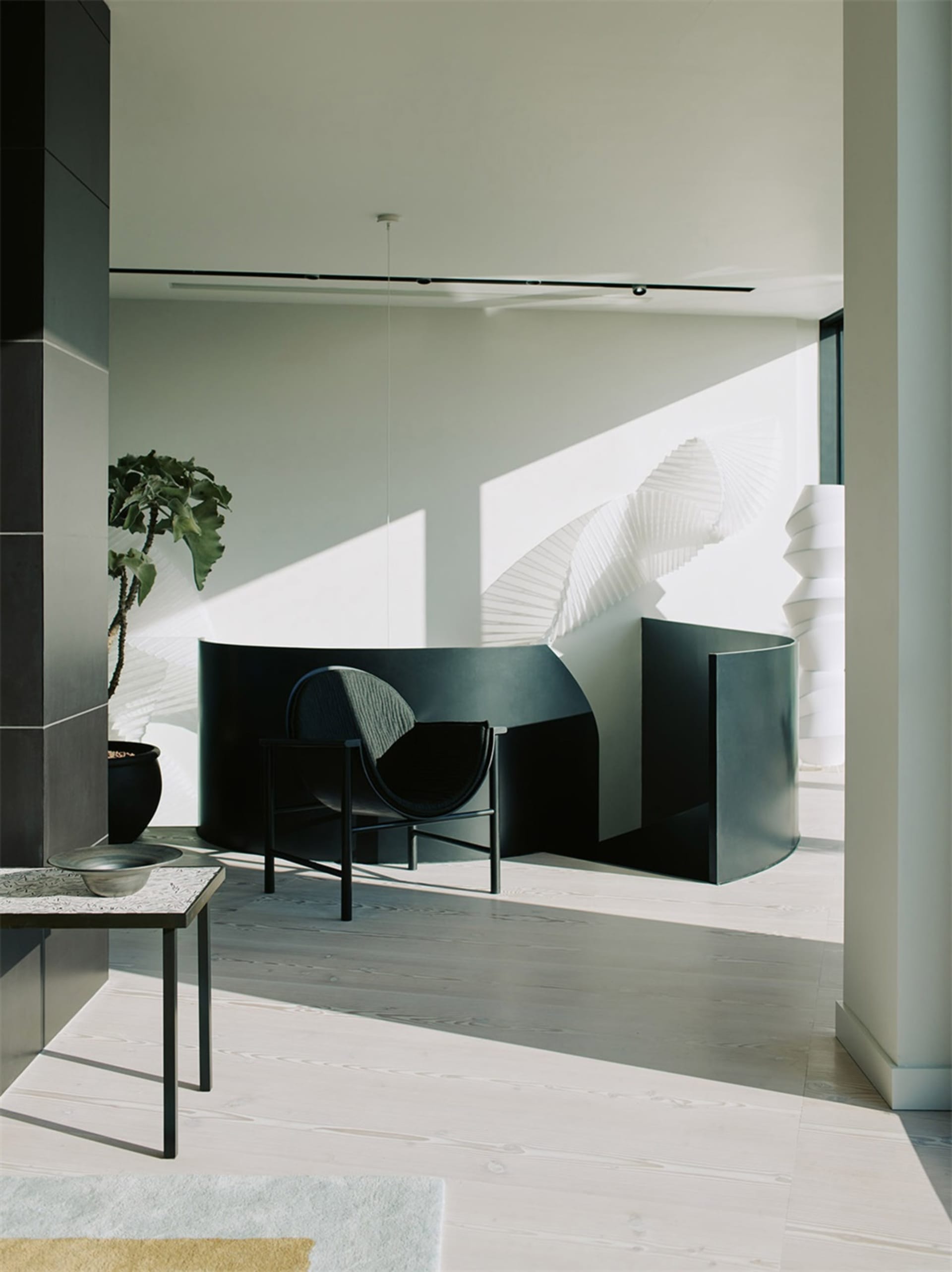 Modern interior design featuring black metal chair and glass partition