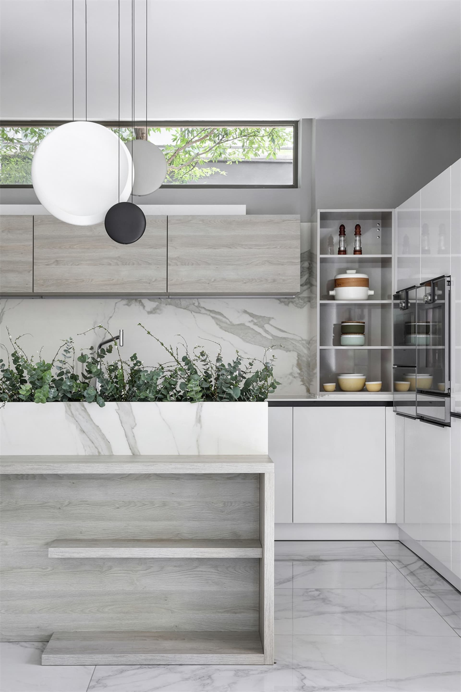 Modern kitchen featuring marble countertops and flooring.