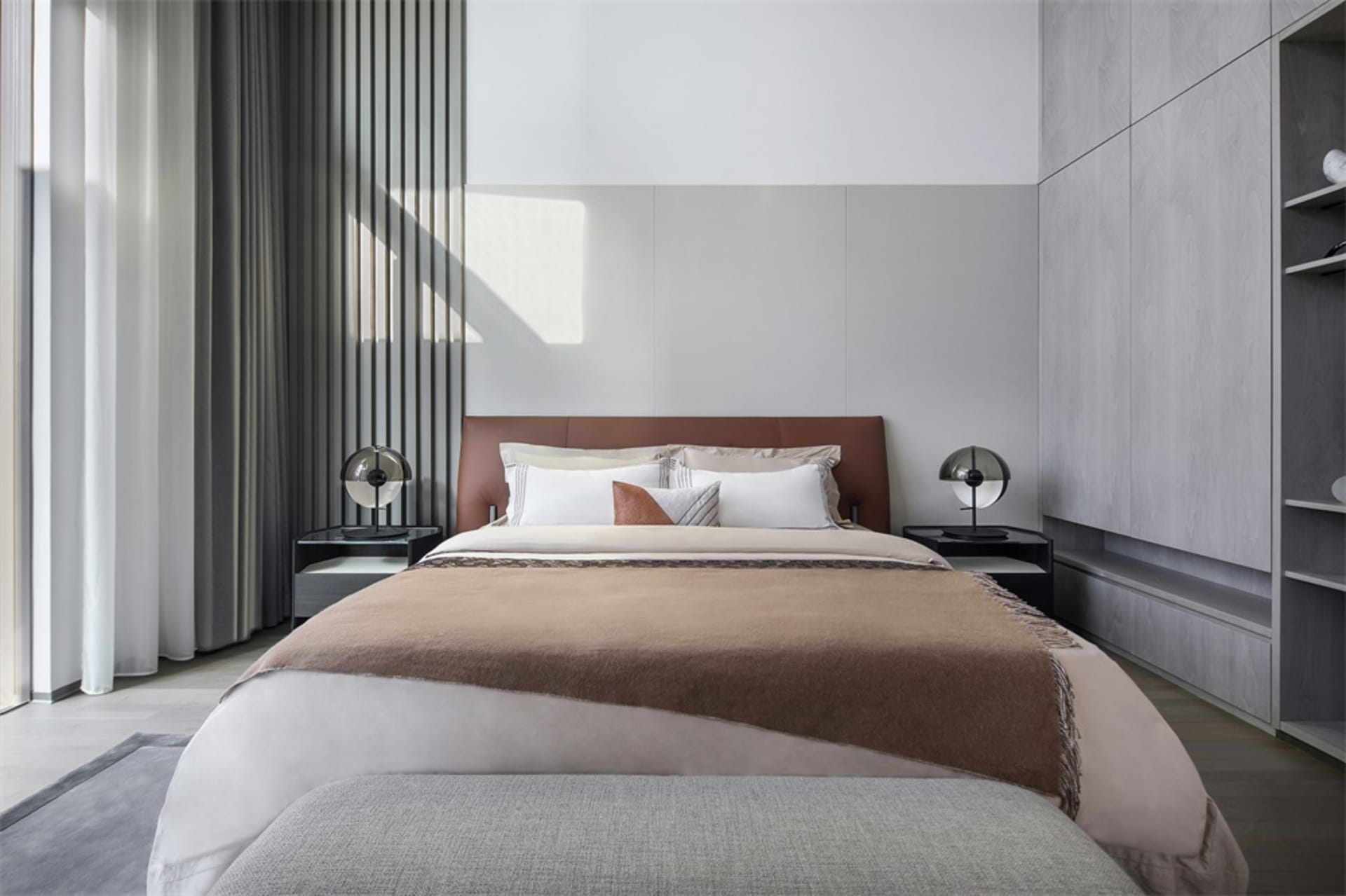 A minimalist bedroom with a neatly made bed, soft lighting, and a sleek, modern design.