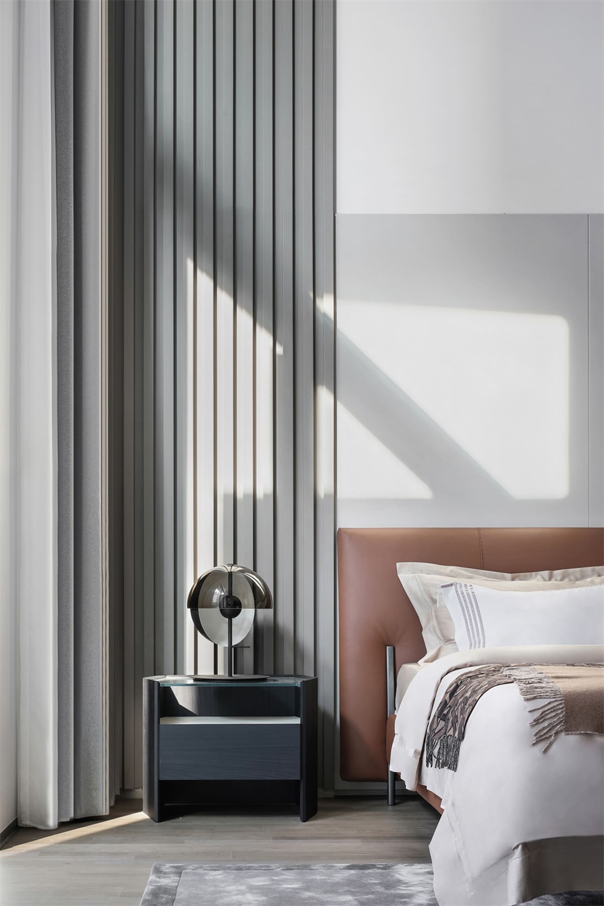 Contemporary bedroom featuring a textured wall and minimalist design elements.