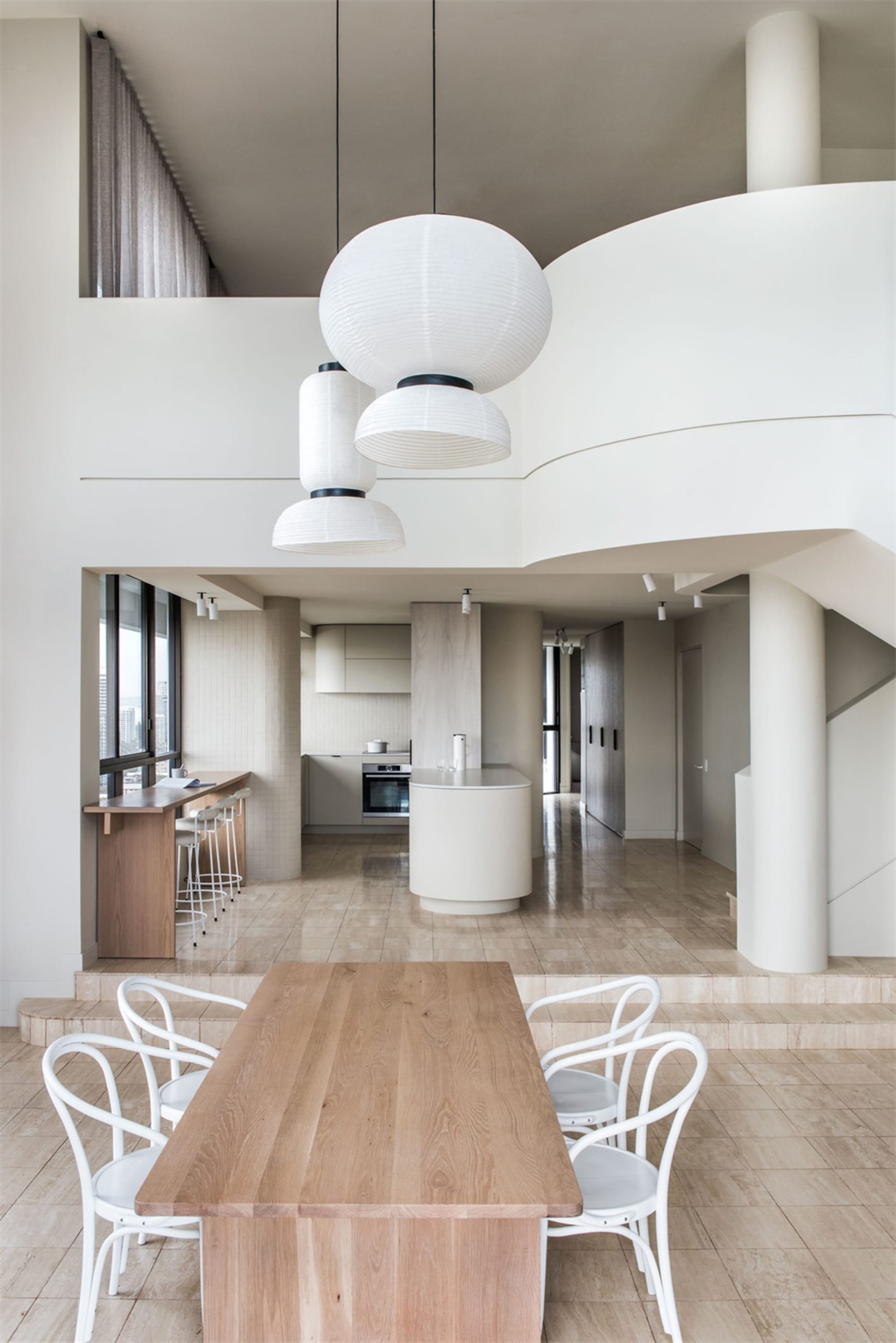 Modern, minimalist kitchen featuring wooden materials and clean lines.
