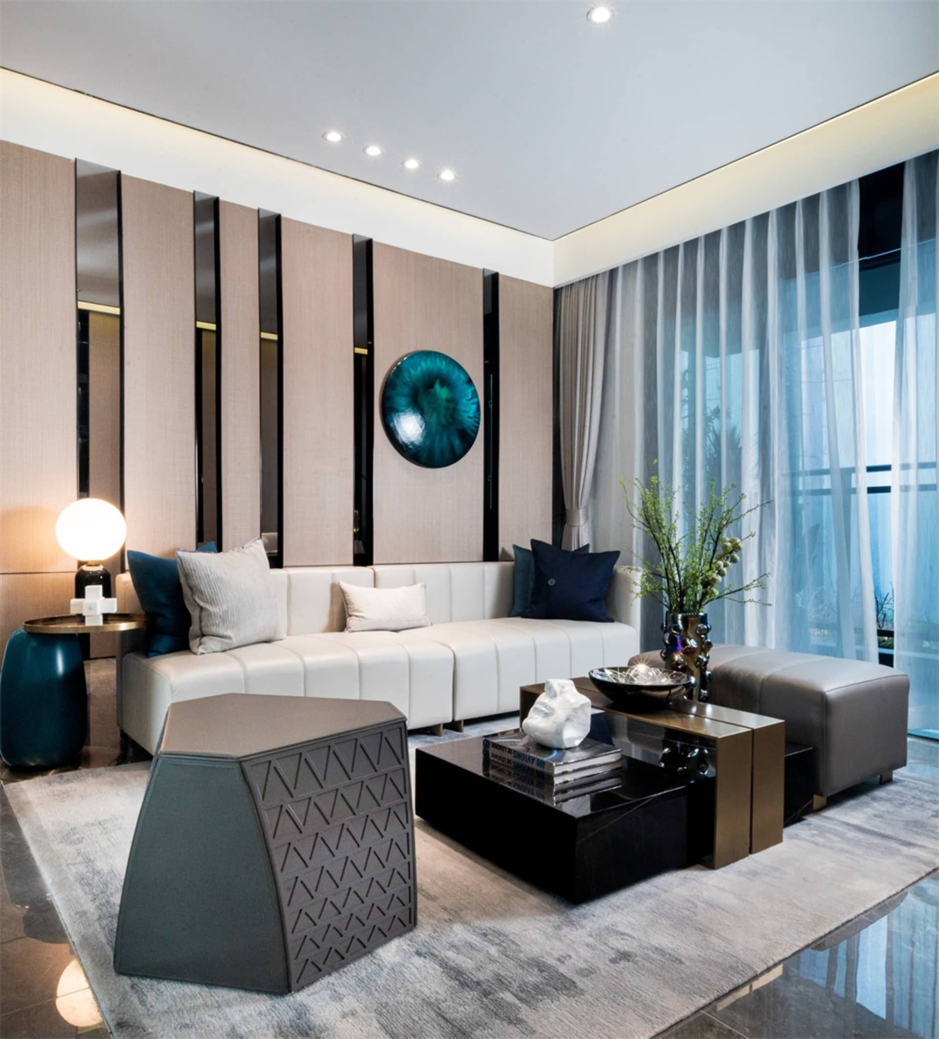 Contemporary living room featuring glass, concrete, and leather elements.