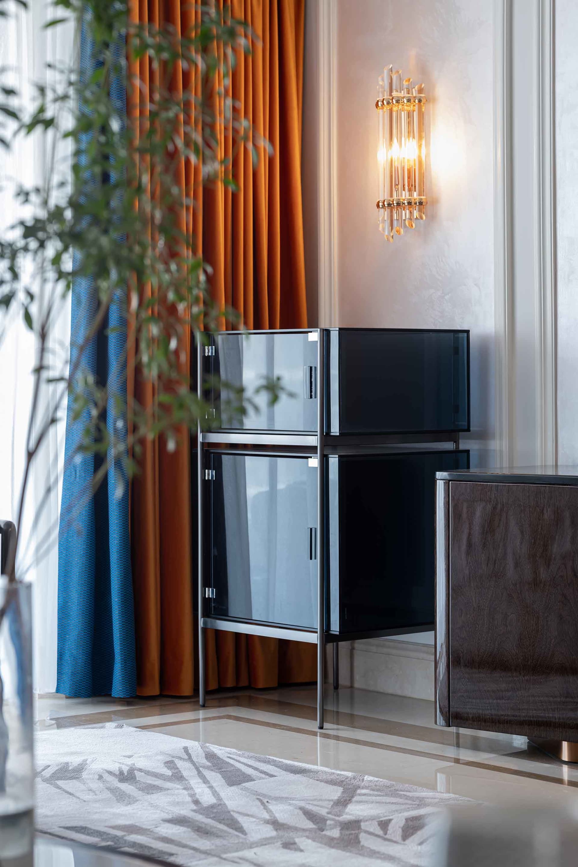 Modern minimalist living room featuring metal frame, glass doors, and marble top side table.