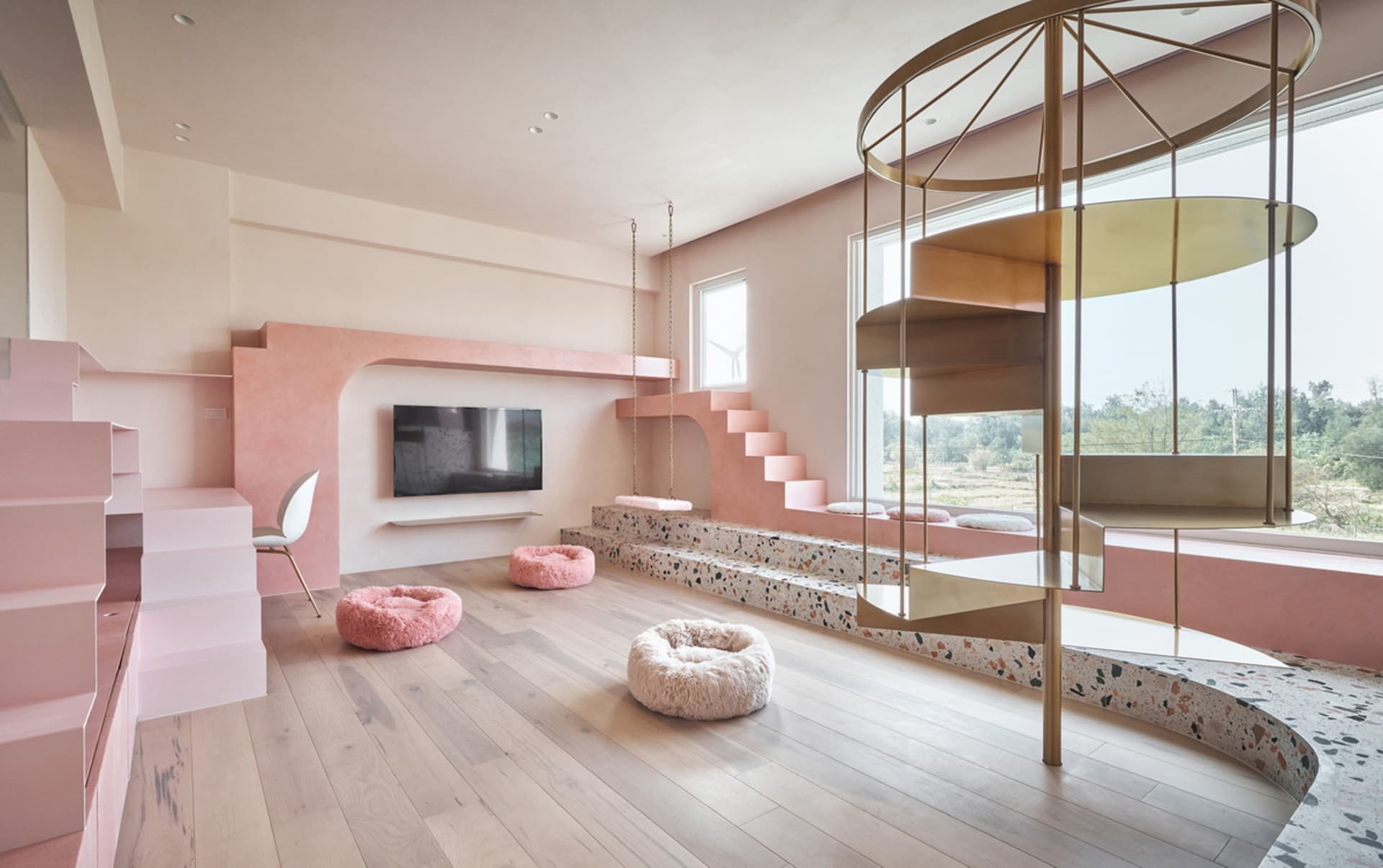 Modern minimalist living room with pink concrete walls and floors, featuring a spiral staircase and plush seating areas.