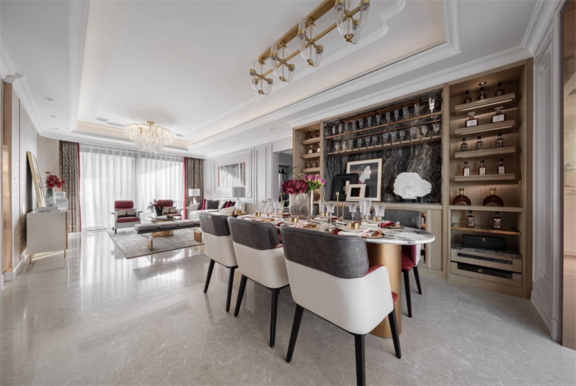 Modern dining room featuring marble table and chairs, with a bar area and wine rack.