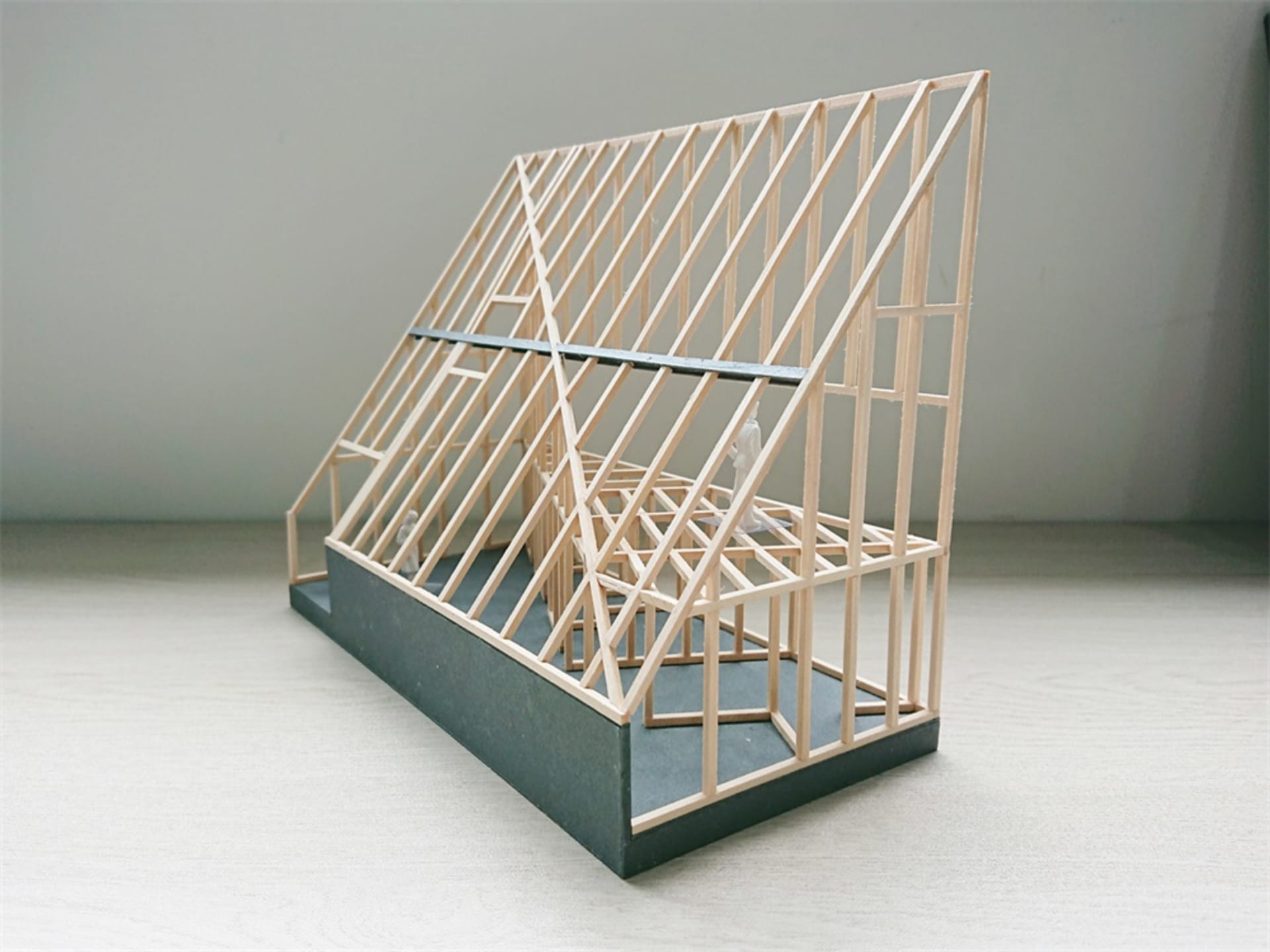 A detailed architectural model depicting a house made of wood.
