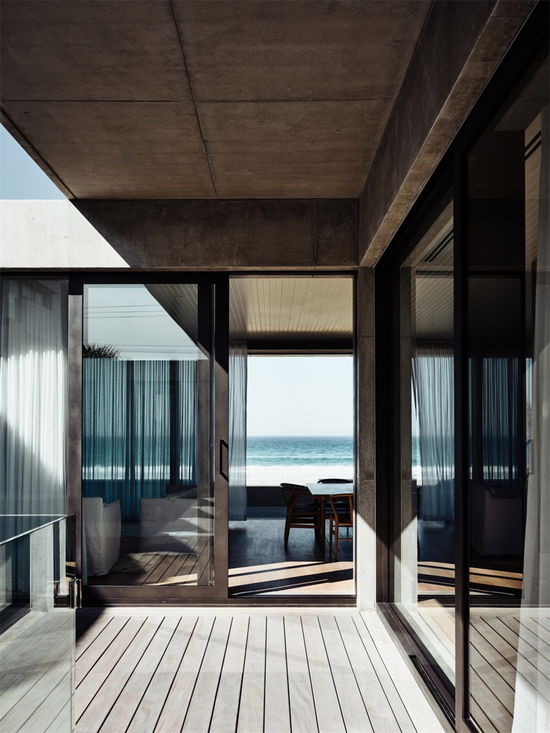 Modern apartment with floor-to-ceiling windows overlooking the ocean