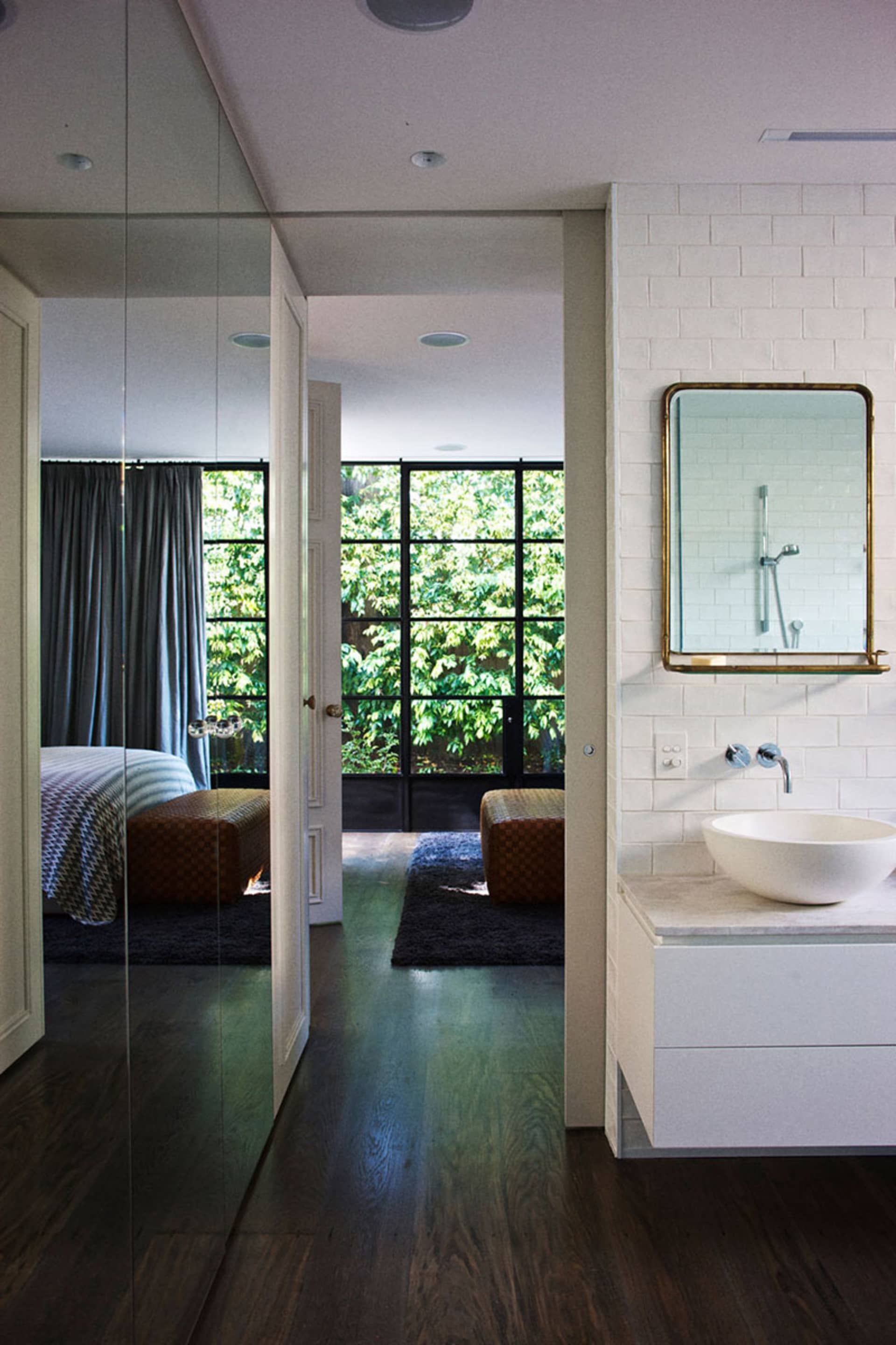 Modern bathroom with white tiled walls and a minimalist design.