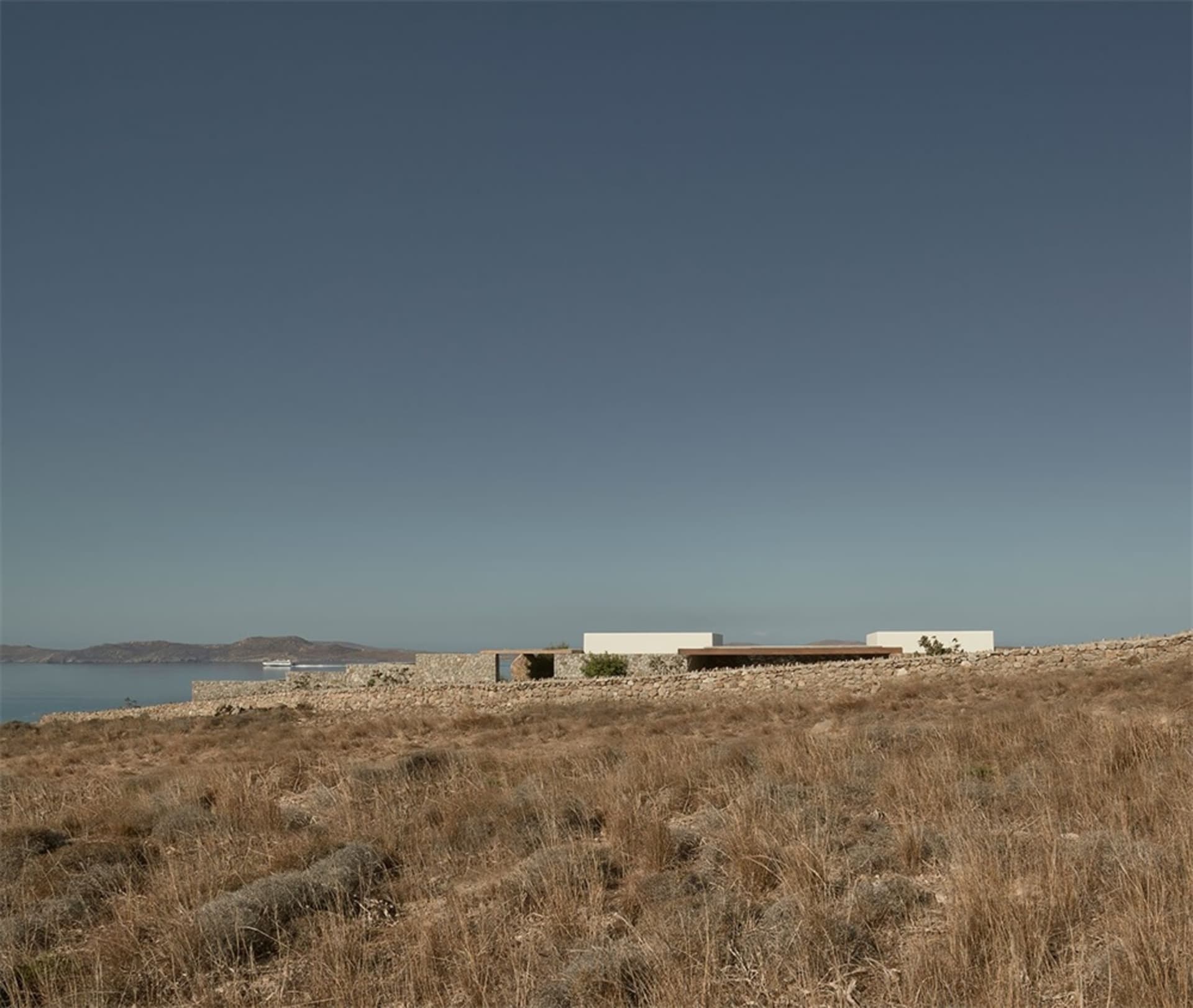 Modern living space with rock walls and a view of the canyon.