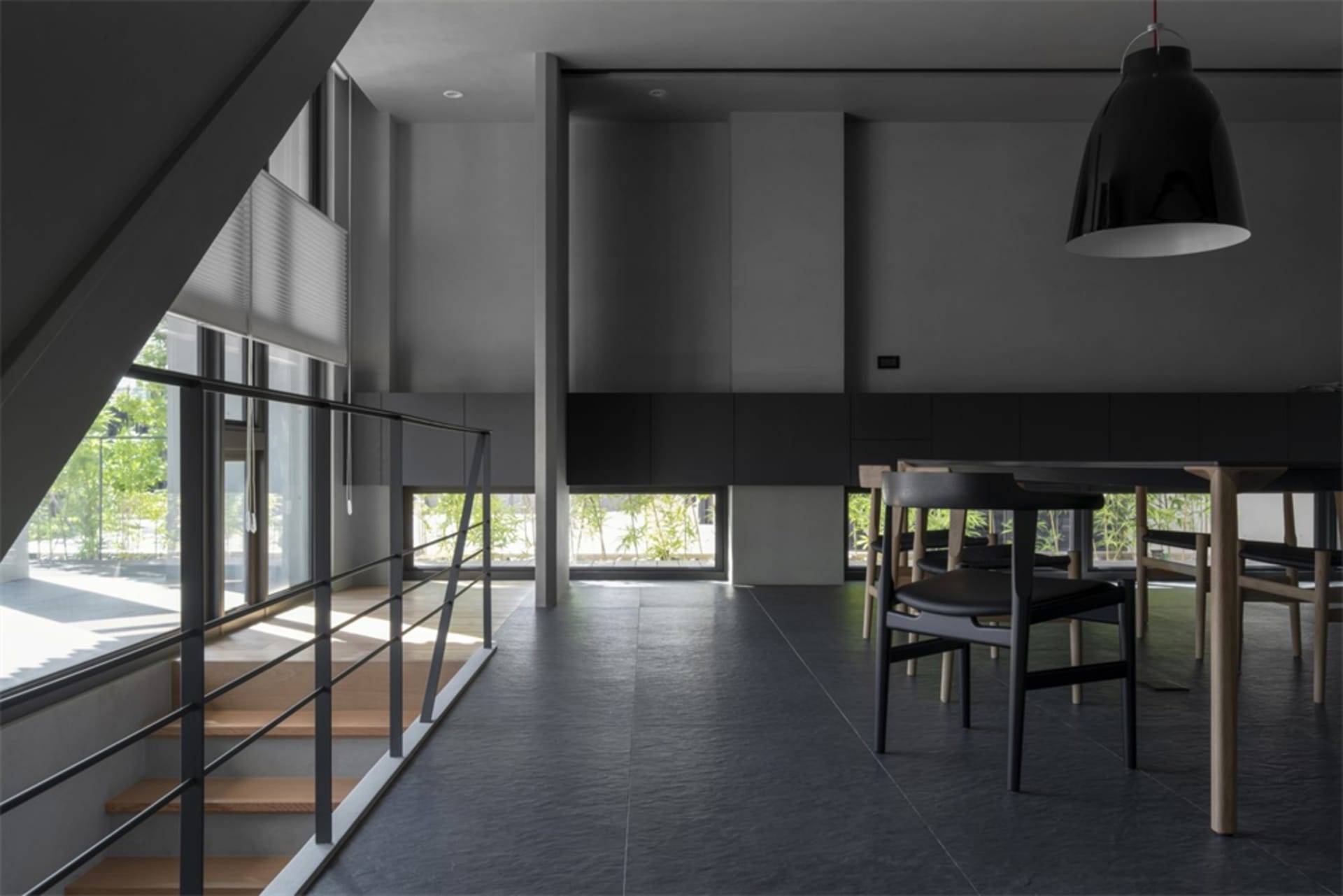 Modern residential dining room featuring concrete flooring and minimalist design.