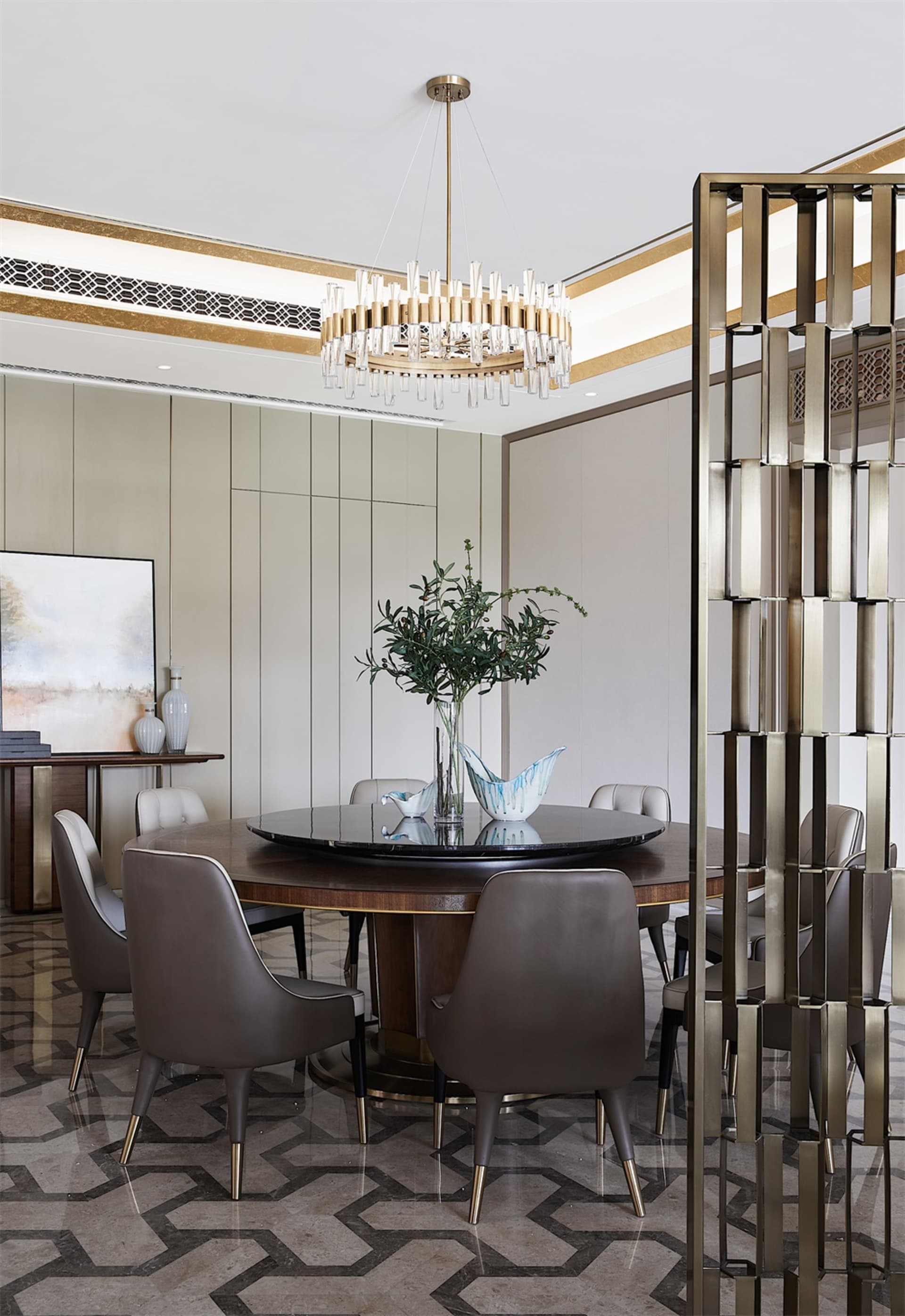Modern dining room with marble flooring and table, featuring a round dining table surrounded by brown leather chairs, and a c