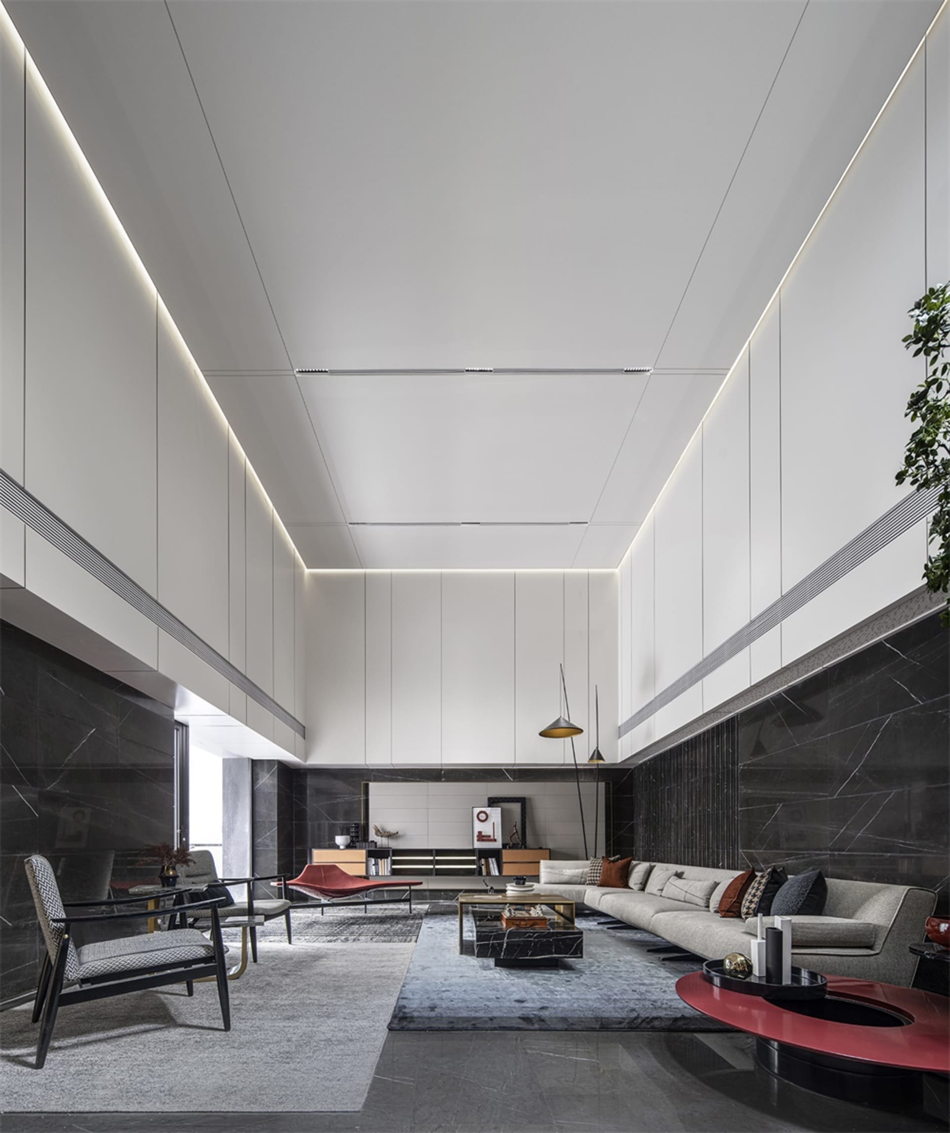 A modern, minimalist living room featuring marble elements and a high, open ceiling.