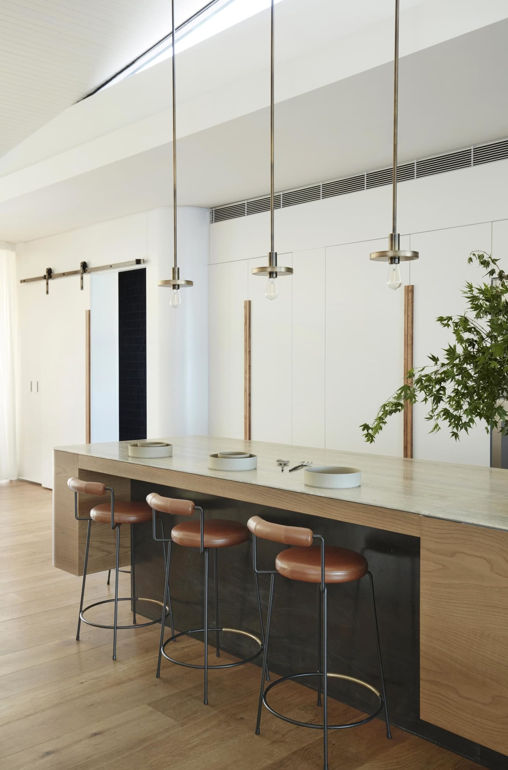 Modern kitchen with concrete countertops and leather stools
