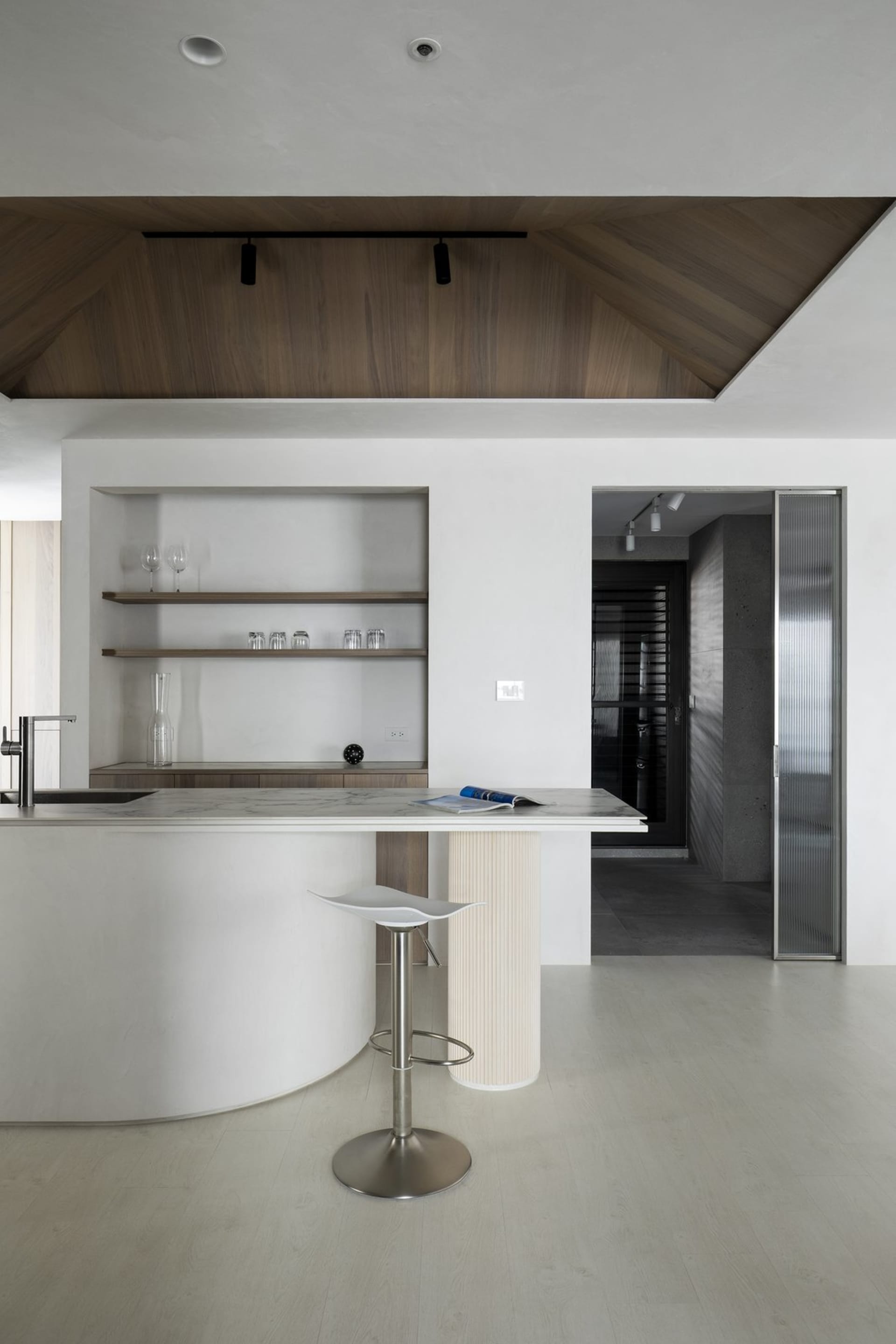A modern kitchen featuring a white marble countertop and minimalist design.