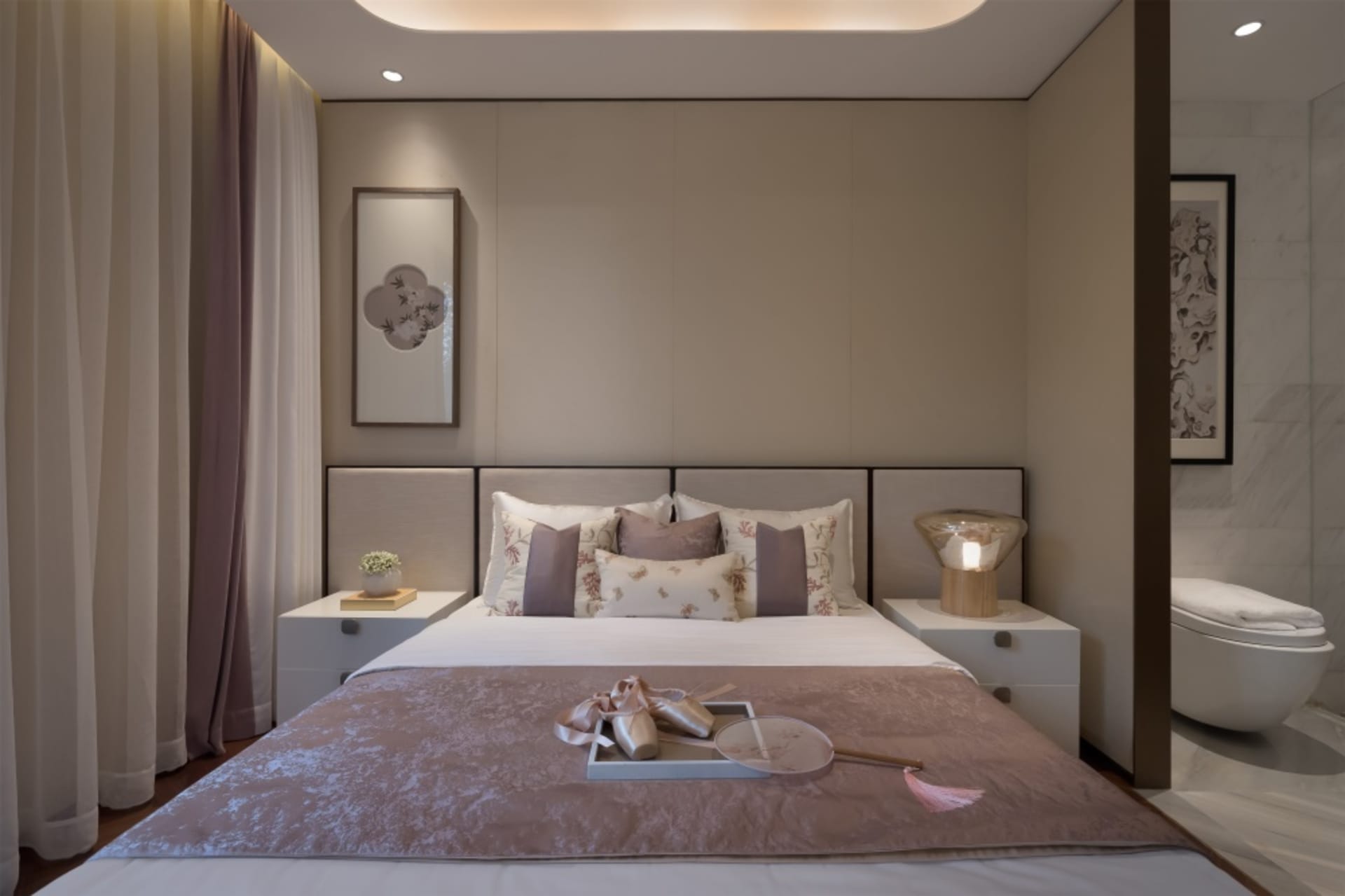 Modern minimalist bedroom with a bed featuring floral-patterned bedding, white and beige tones, and a floating bedside table 