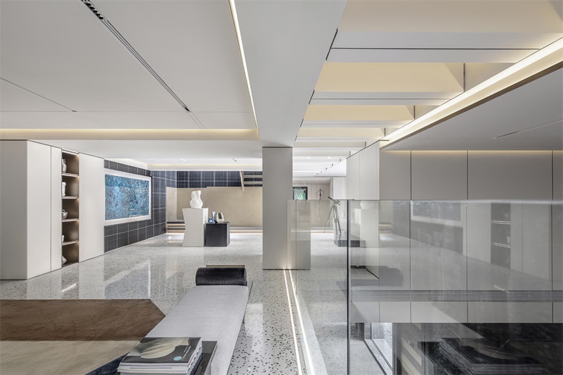 Modern minimalist lobby featuring concrete and glass materials.