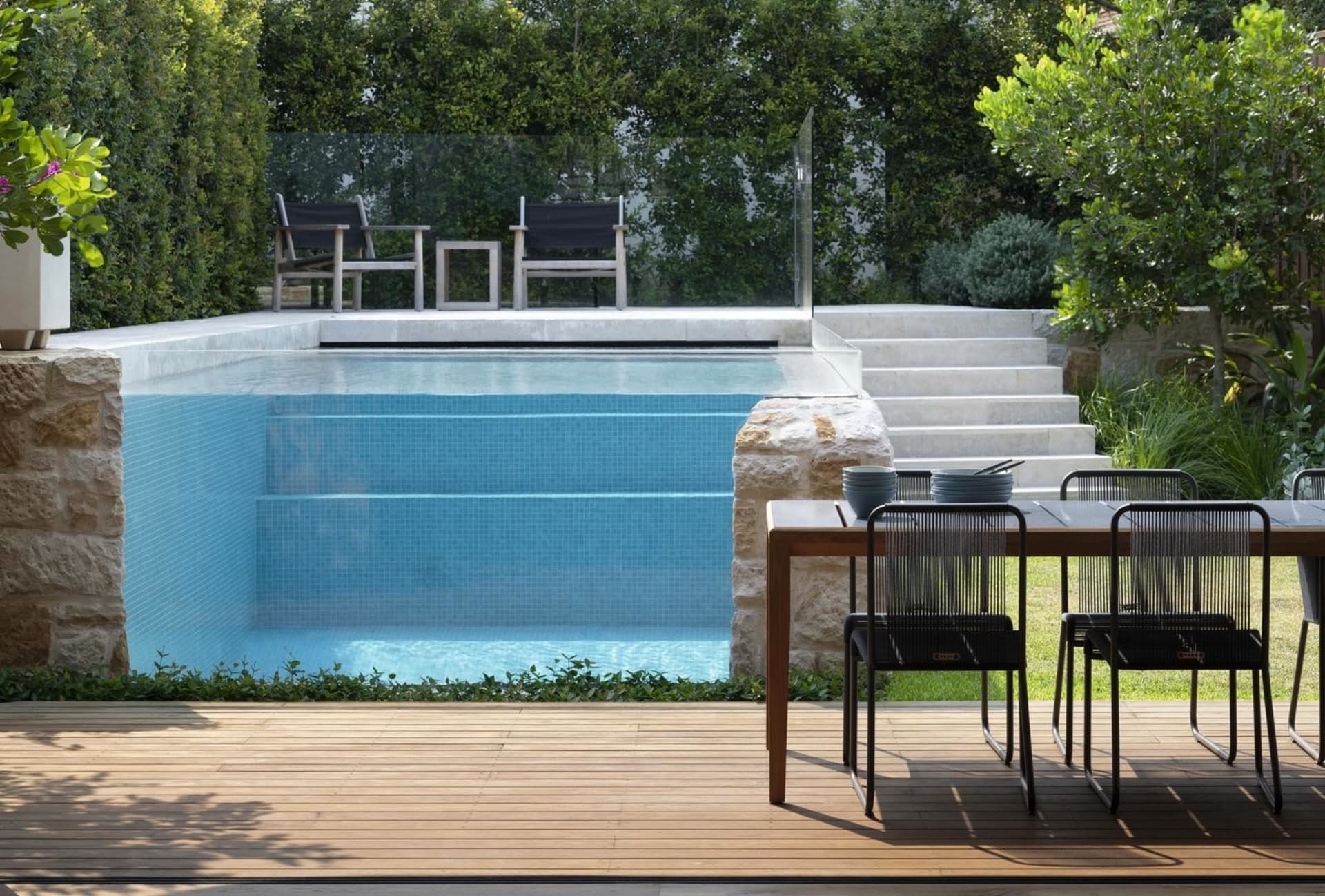 Modern outdoor residential area featuring wood, glass, and marble materials.