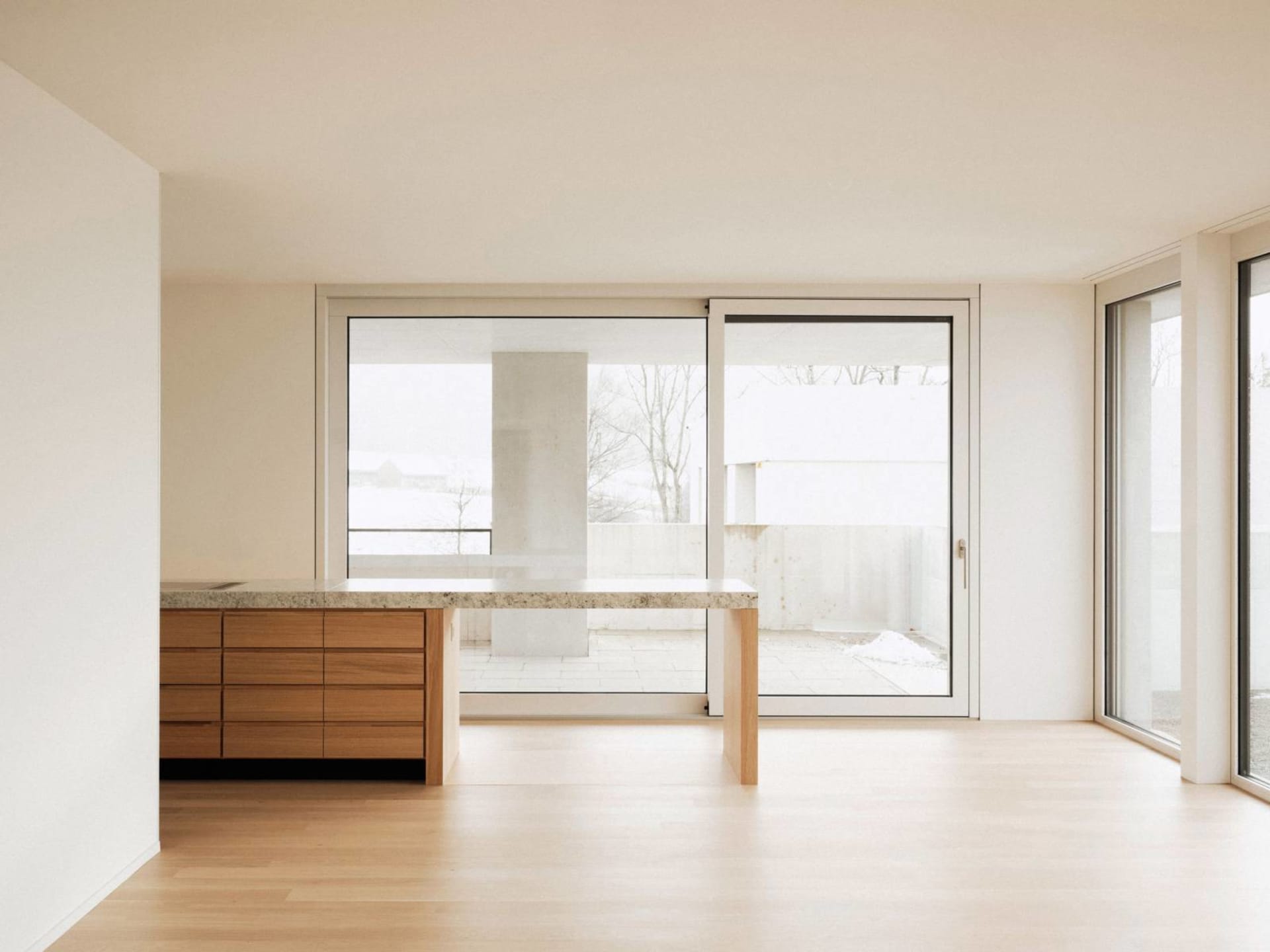 A modern residential kitchen featuring wooden cabinets and a stone countertop.