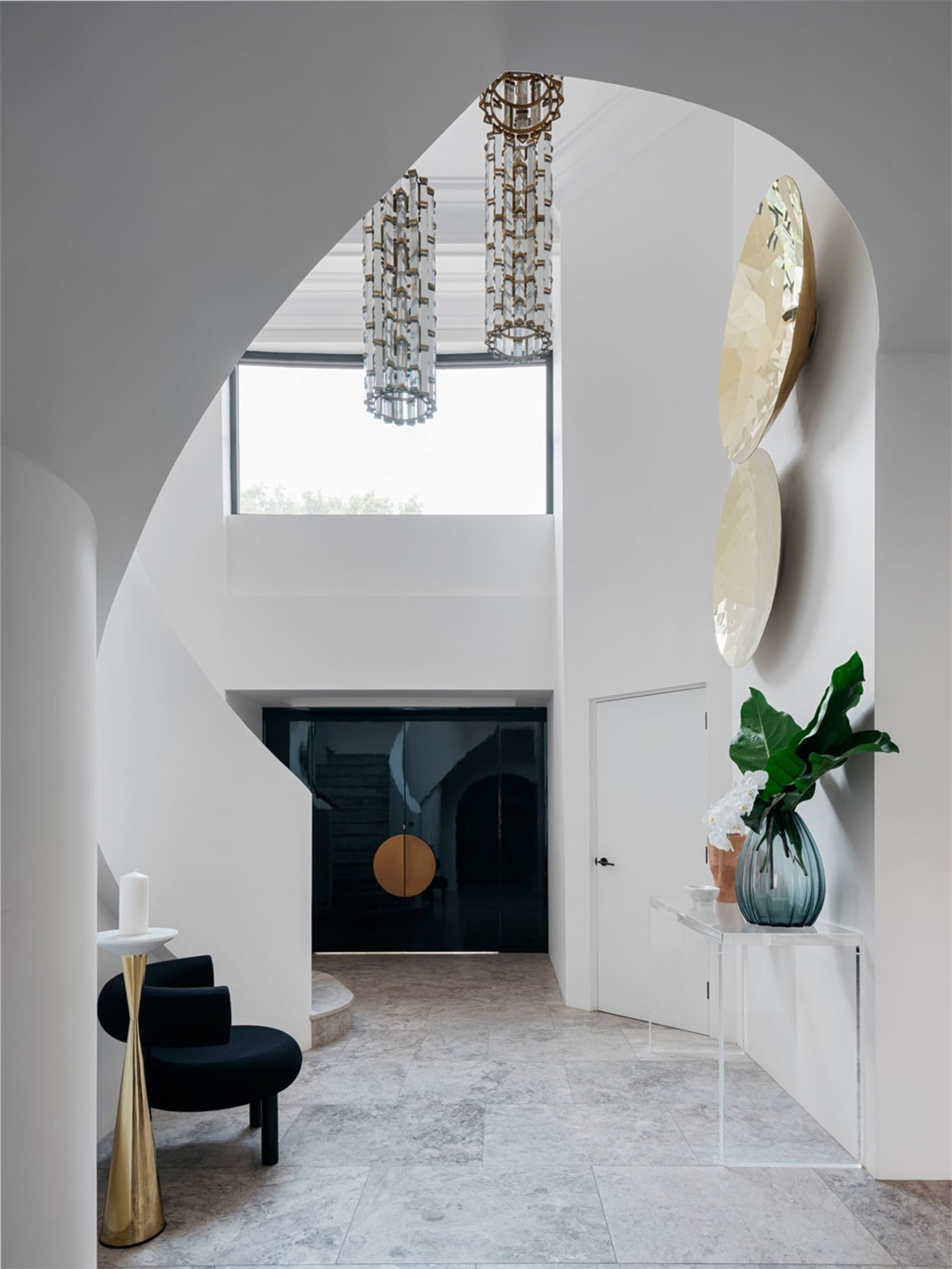 Modern entryway featuring glass and marble materials.
