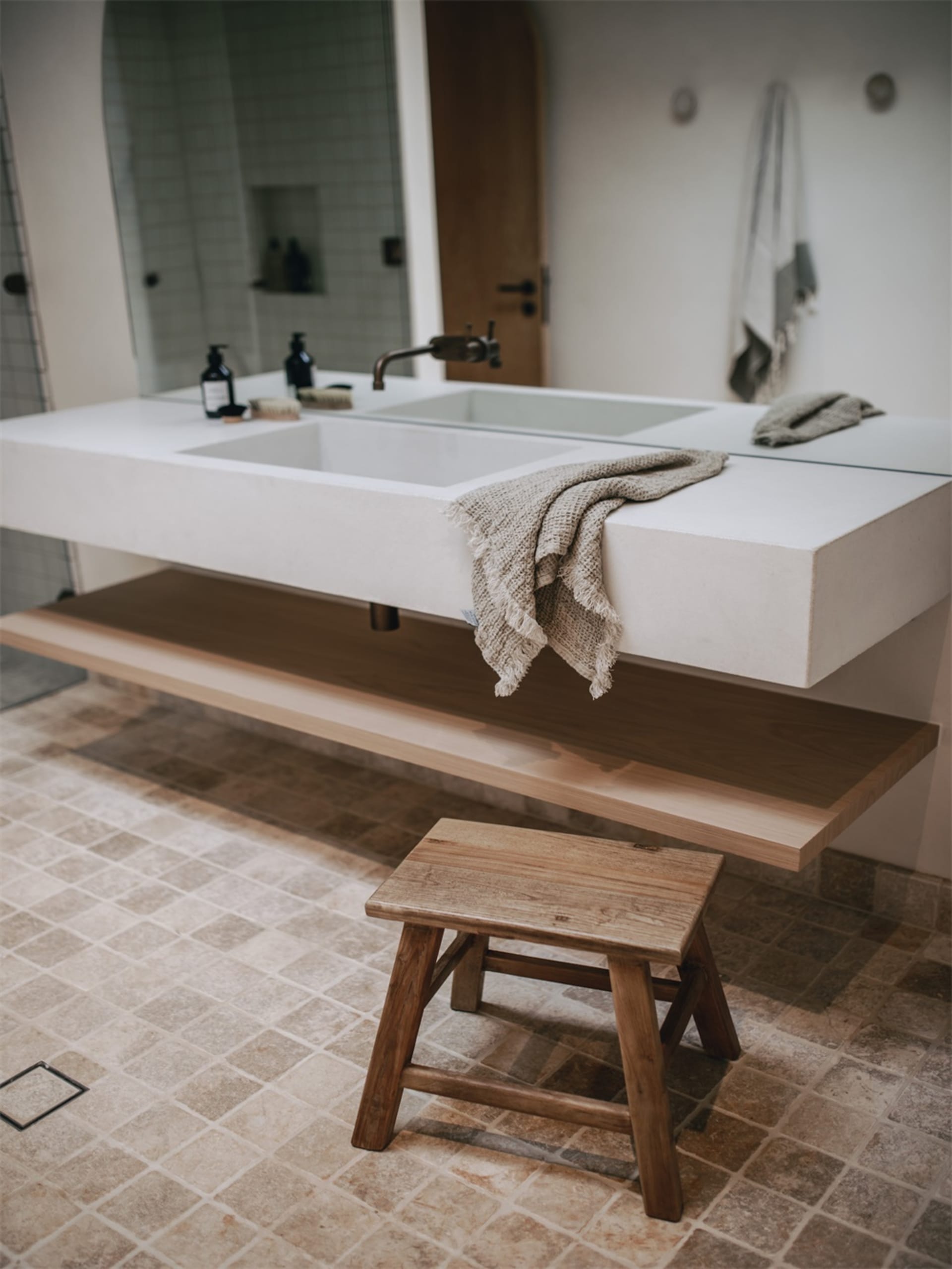 A minimalist bathroom with a concrete countertop and wall, clean lines, and a modern design.