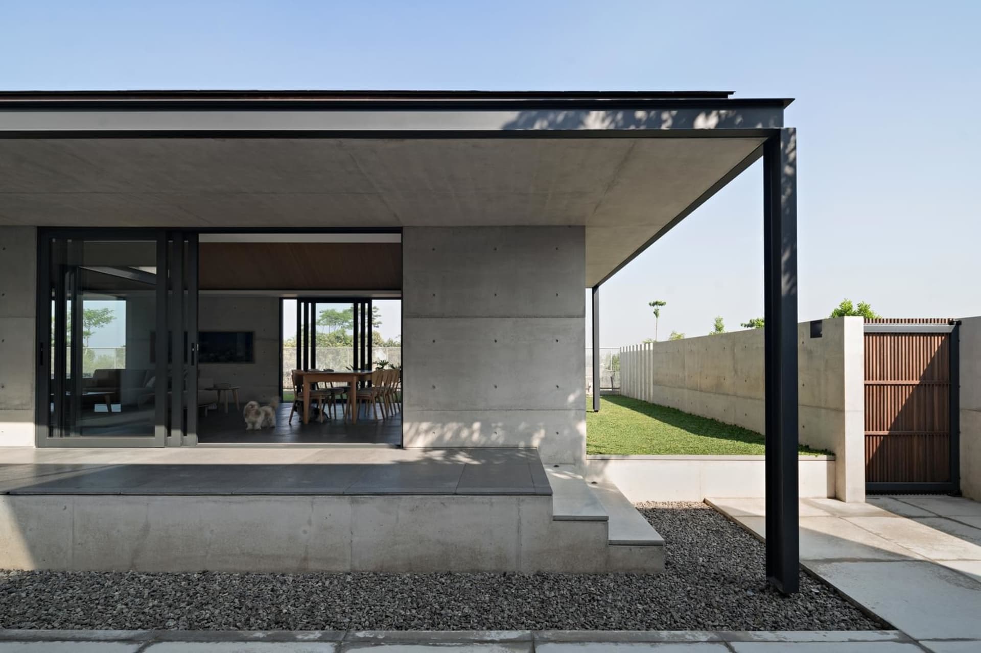 Modern architectural exterior featuring concrete walls and a minimalist design.