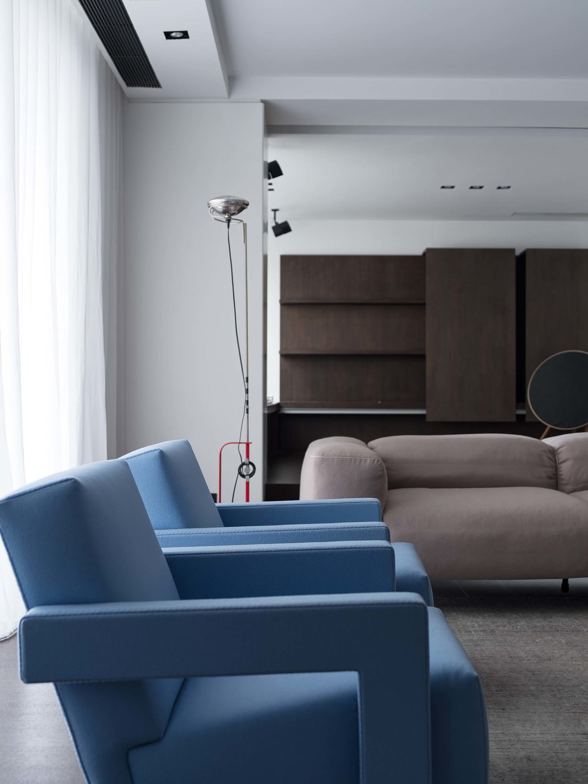 Modern living room with blue fabric sofa and minimalist design.