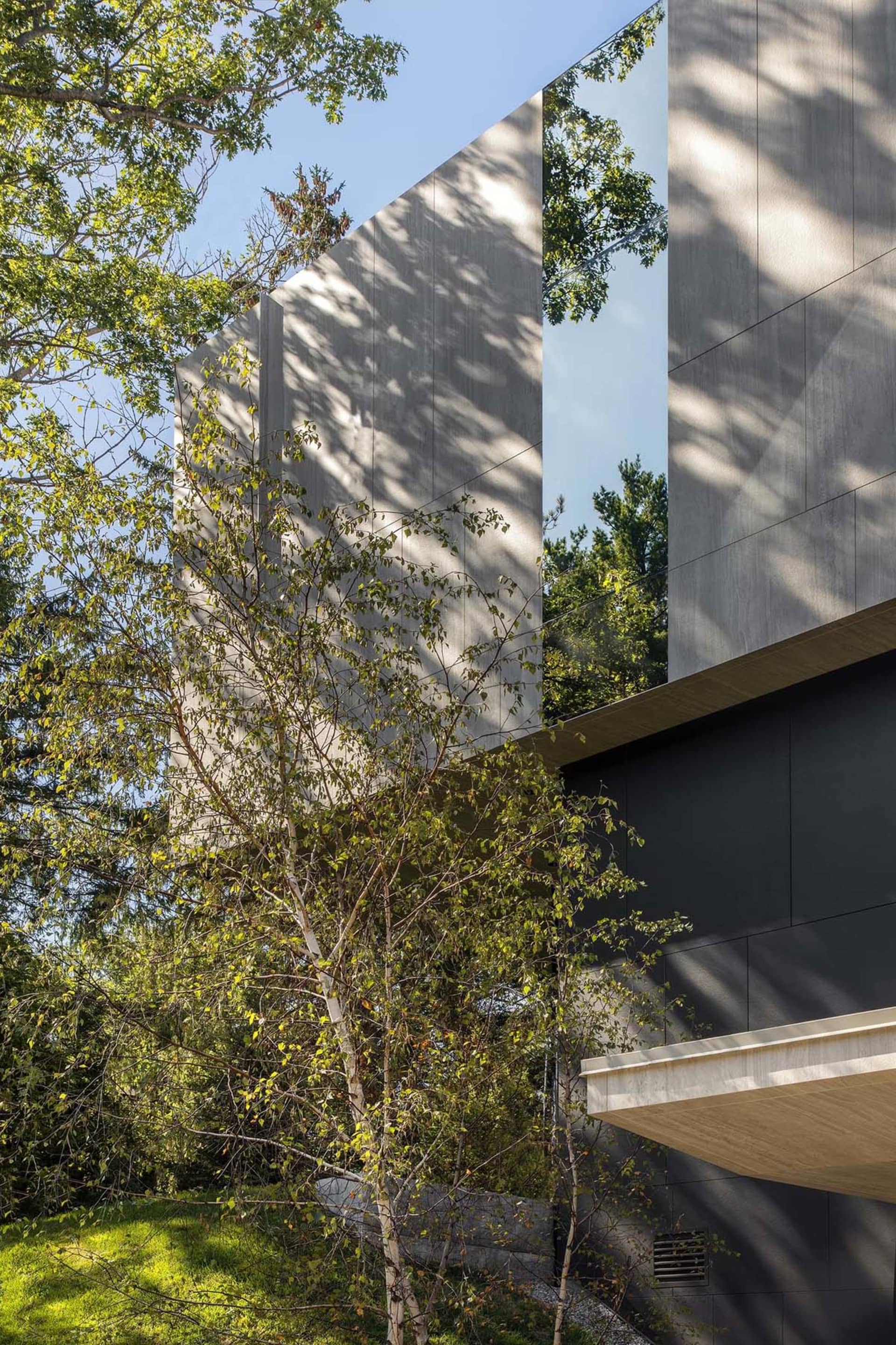 Modern residential building with concrete and glass exterior materials.