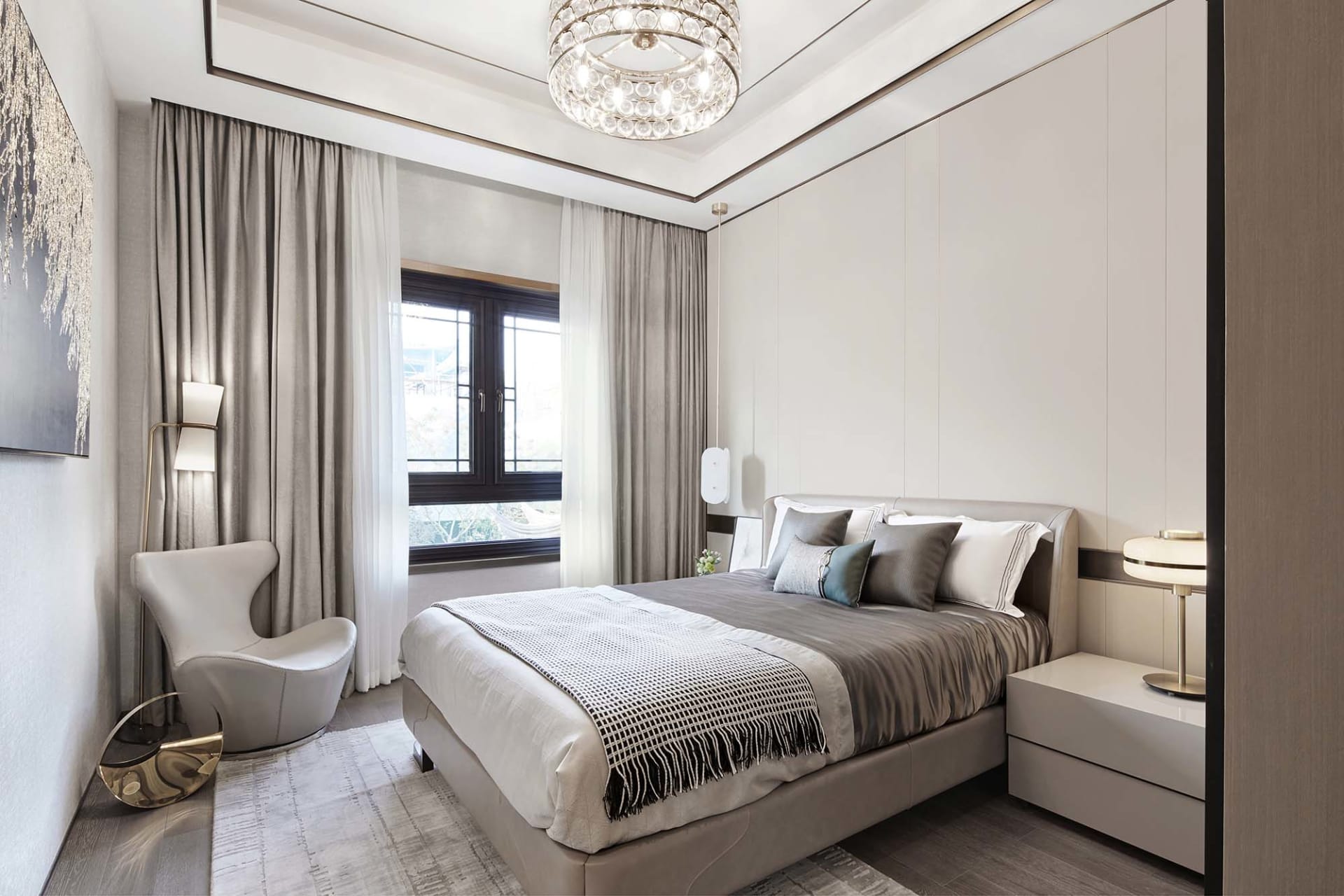 A modern bedroom featuring gray and taupe colors with a bed, nightstands, and a contemporary armchair.